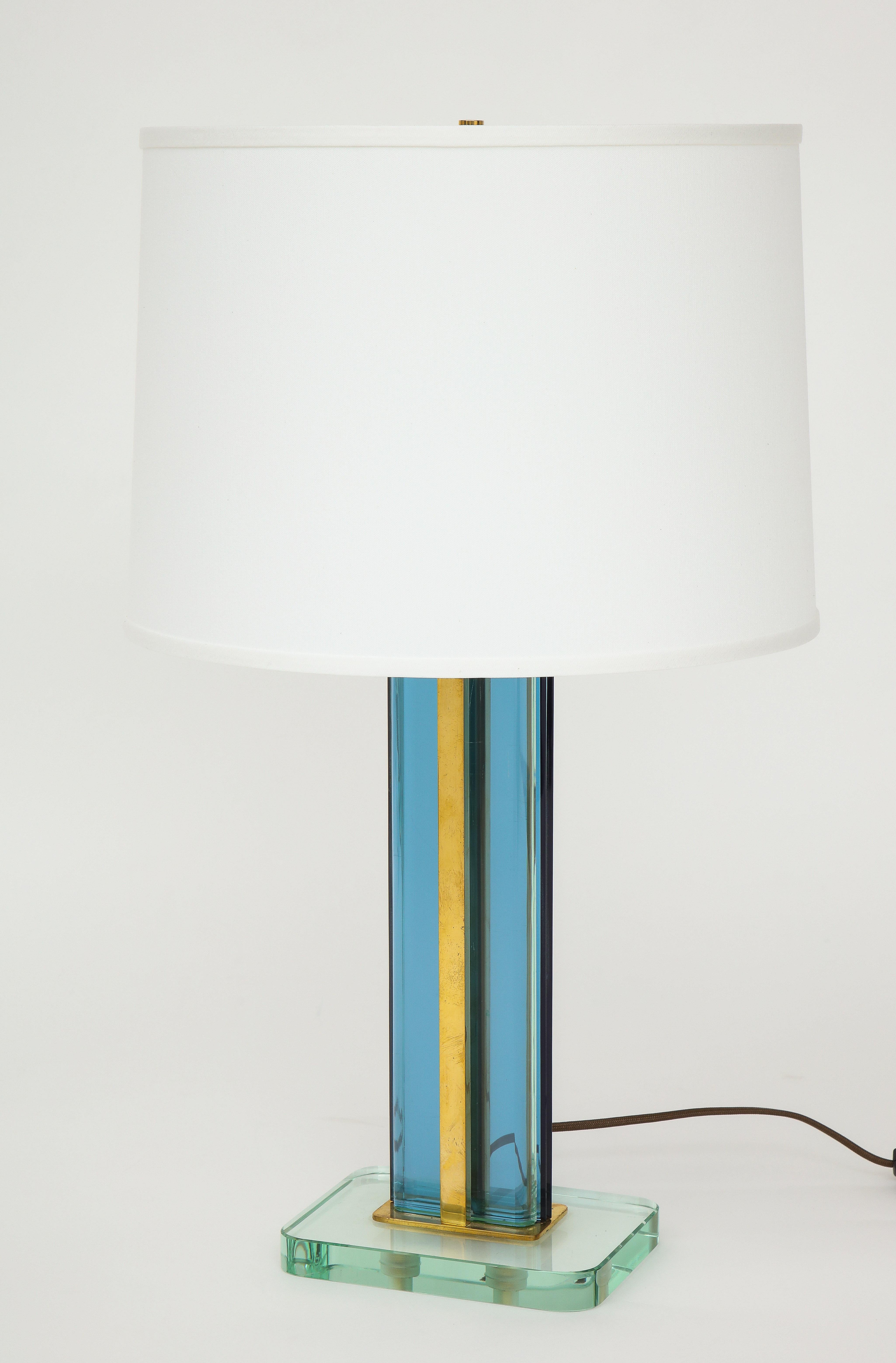 Pietro Chiesa for Fontana Arte rare and lovely two color table lamp with blue glass stem on a thick clear rectangular glass base with brass fittings. Recently rewired to U.S. standards with new white silk shade and silk cord.

Literature:
Franco