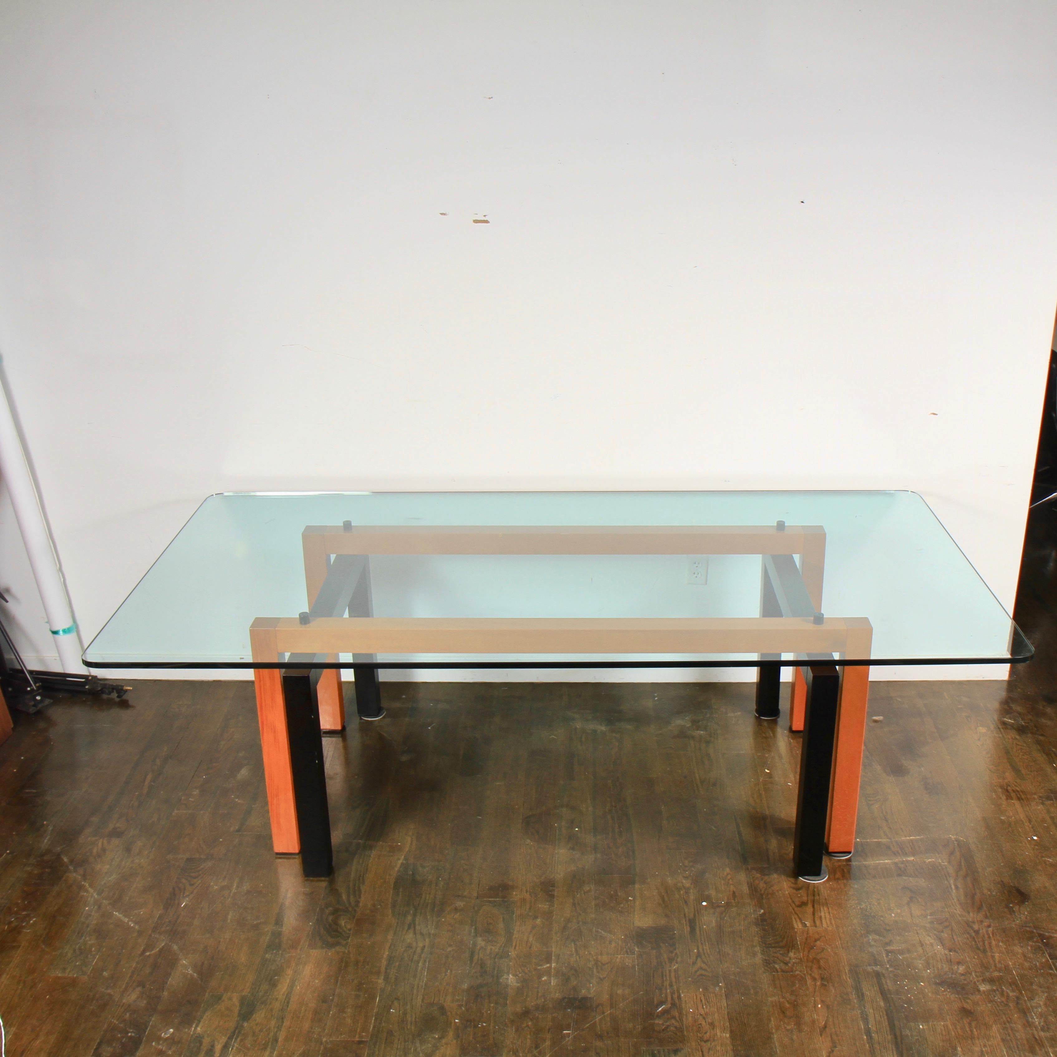 A modern eight foot glass topped dining table by renowned Italian furniture maker Costantini Pietro. With a rather impressive 3/4 inch thick tempered glass top that is extremely clean, resting upon an angular set of pedestals; one finished in ebony,