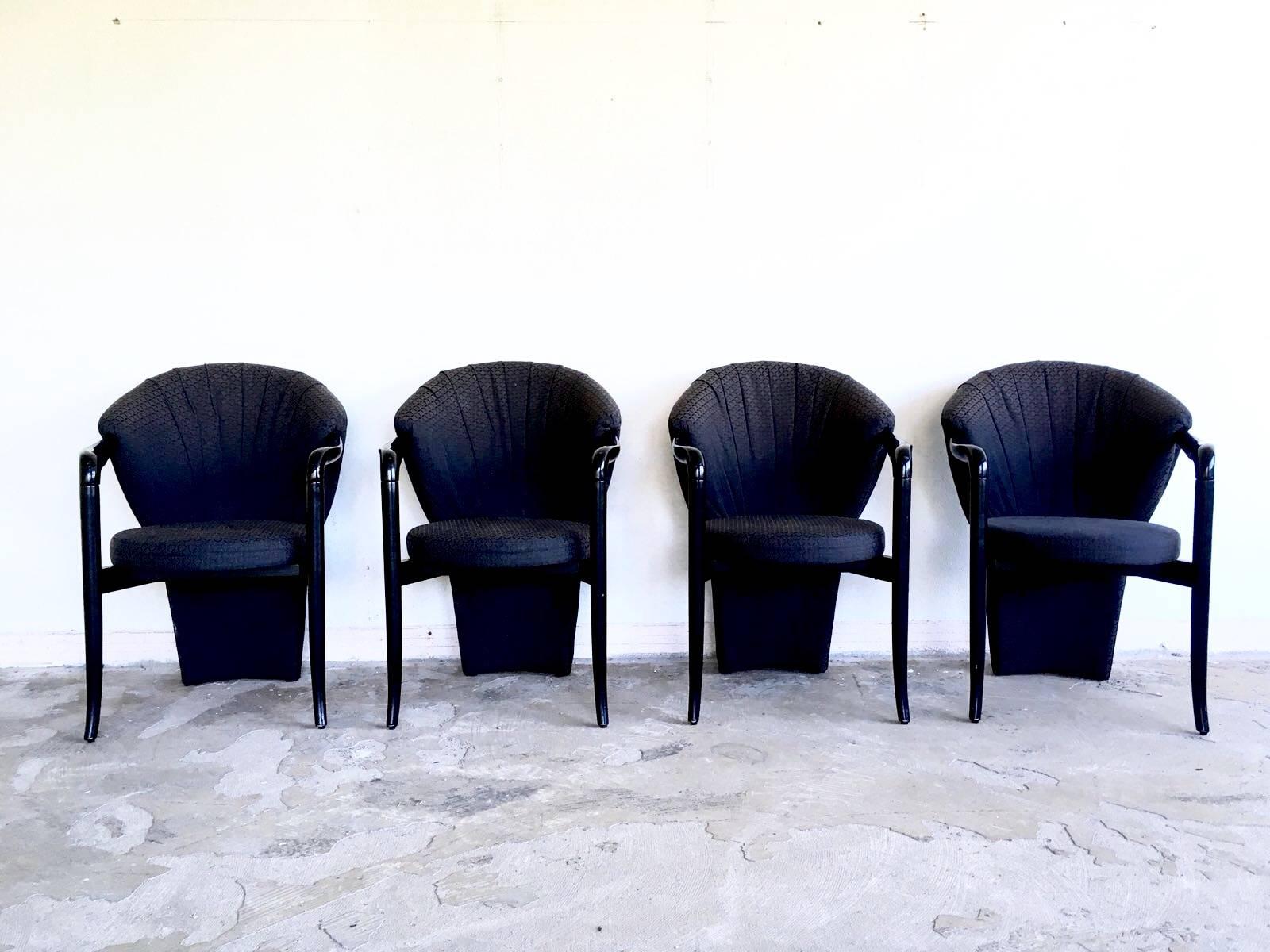 Majestic and exclusive style dining room chairs with Pietro Constantini as their designer. This set consists of four typical 1980s style chairs and feature black lacquered base with a black pattern colored fabric. They remain in good condition, with