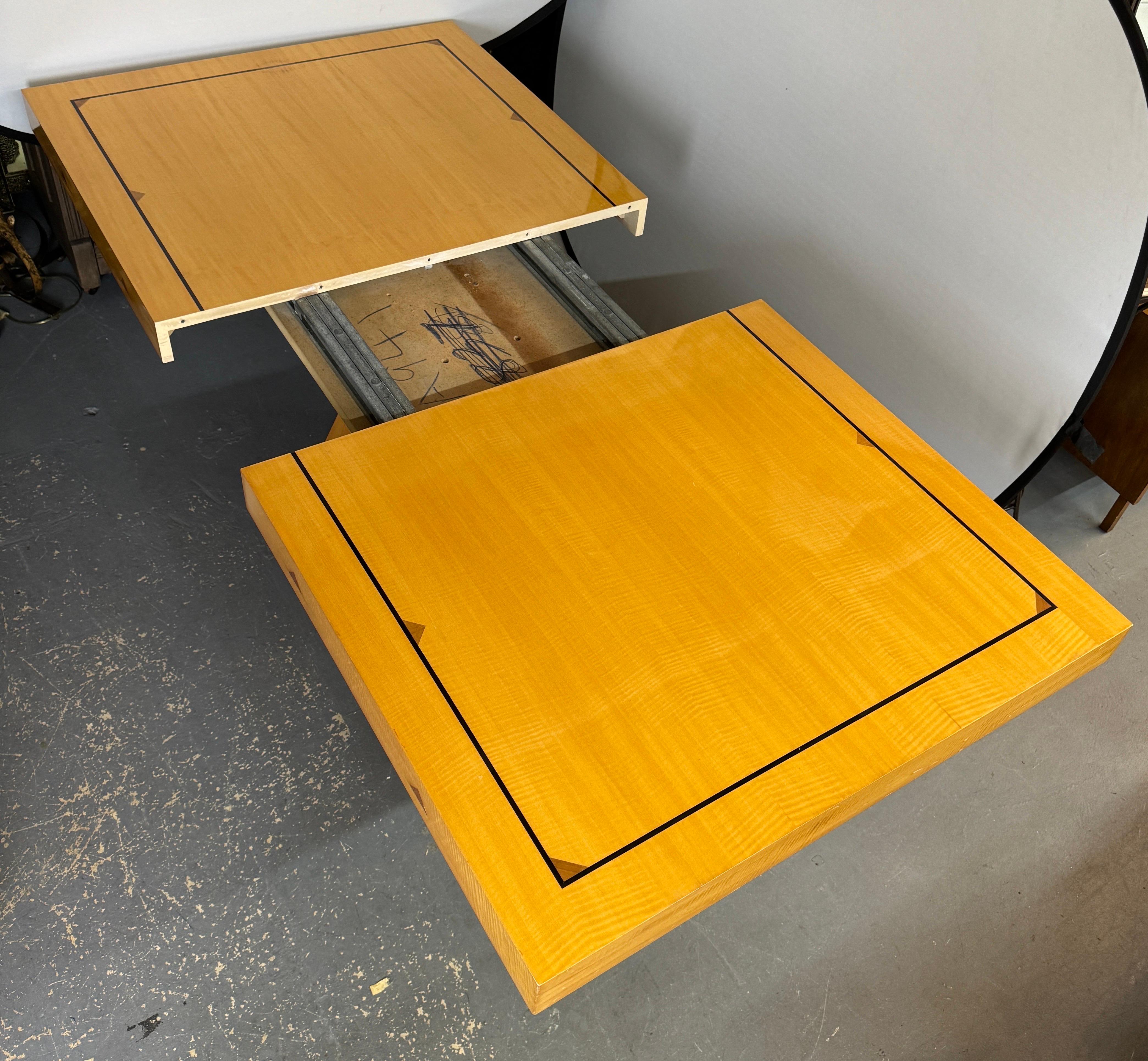 A post-modern contemporary Pietro Costantini dining table with extension and matching 6 dining chairs. 
The dining table's top, crafted from beautiful maple grained wood with a lacquer finish.  The edges of the tabletop are cleanly defined, with