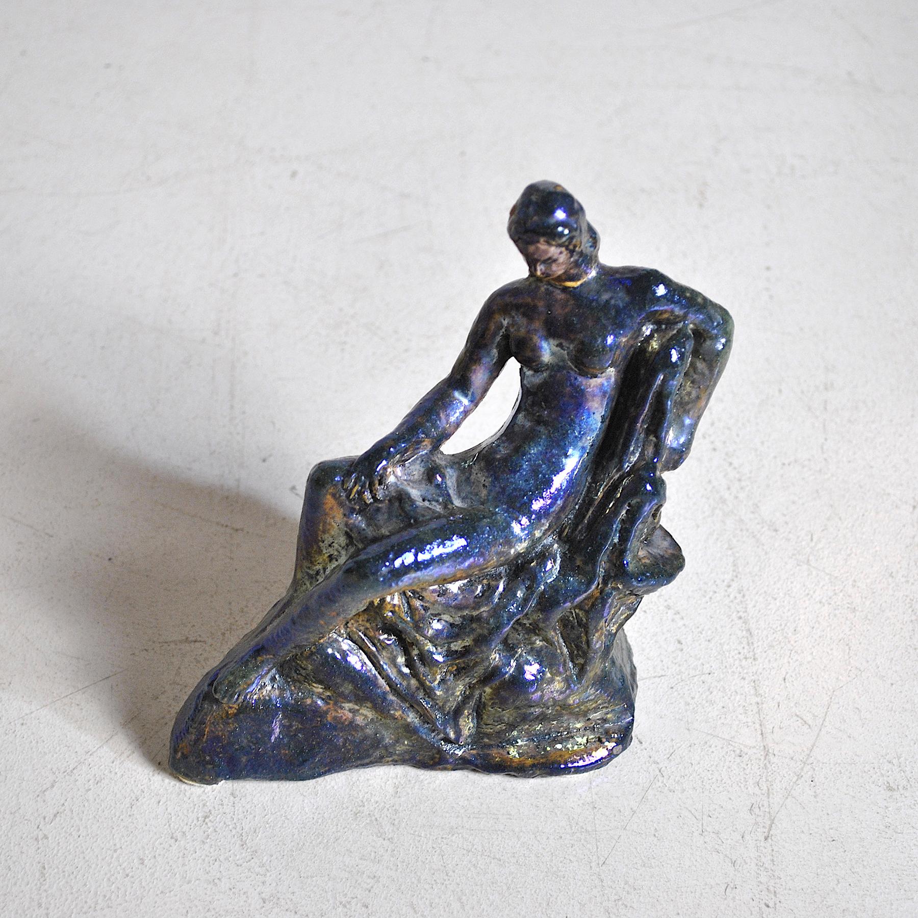 Figure of a woman in a reclining pose in reflected Majolica produced by Melandri, Focaccia in the mid-1920s.