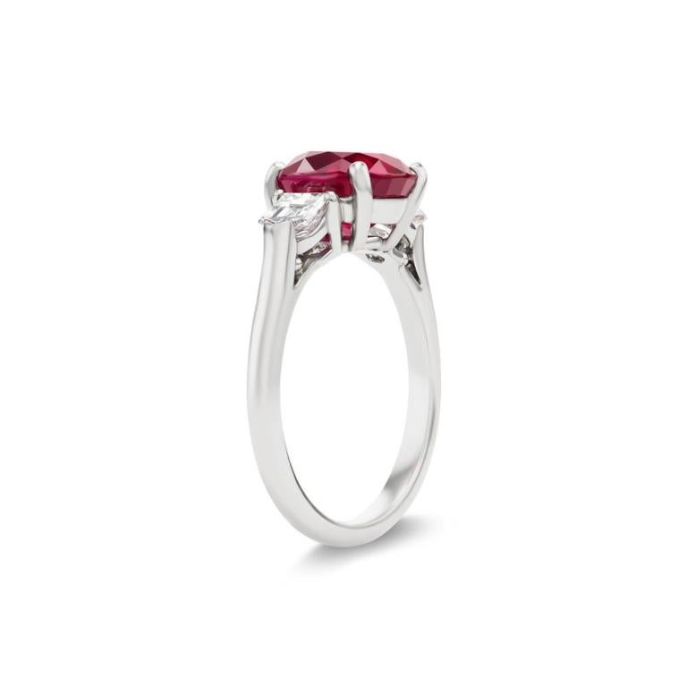PIGEON BLOOD BURMESE RUBY AND DIAMOND RING Two radiant bullet shape diamonds set in the finest platinum give life to this elegant 3 ct Oval shaped Pigeon blood colored Ruby Item: # 04059 Metal: Platinum Lab: Gia And C.dunaigre Color Weight: 3.14 ct.