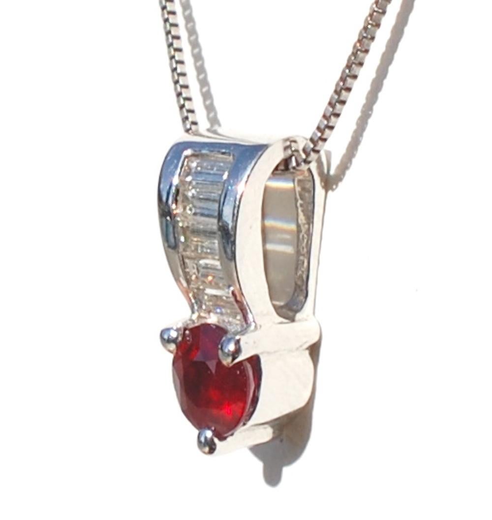 Pigeon Blood Ruby, Baguette Diamond, 18 Kt. Pendant
Quality ruby 4.50 mm weighing .50 carat set in prongs and accented by a row of (5) straight baguette diamonds.  
Diamond quality are VS clarity and H color. Weight of diamonds are .50 carat