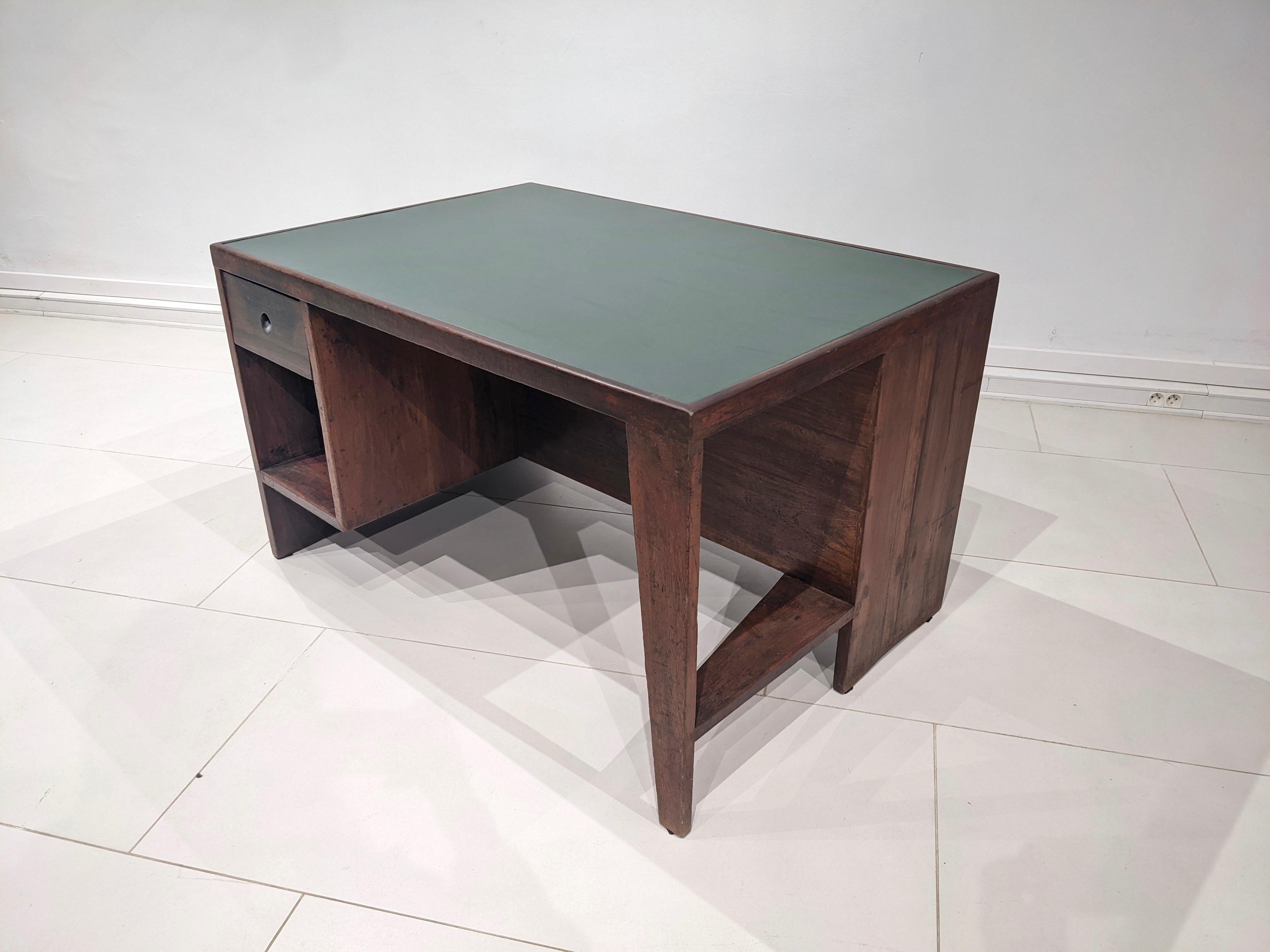 Pigeonhole desk by Jeanneret.
Circa 1957 - 1958. Very good condition. The teak wood has been restored as well as the green leather on the top. 
Designed for the Secretariat, Chandigarh, India.

Dimensions : H 72 cm x W 122 cm x D 84