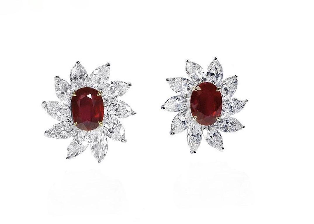 Vivid red rubies from Mozambique surrounded by the whitest of diamonds.  The central rubies weigh over 3cts each and are certified by the Swiss laboratory GRS as 