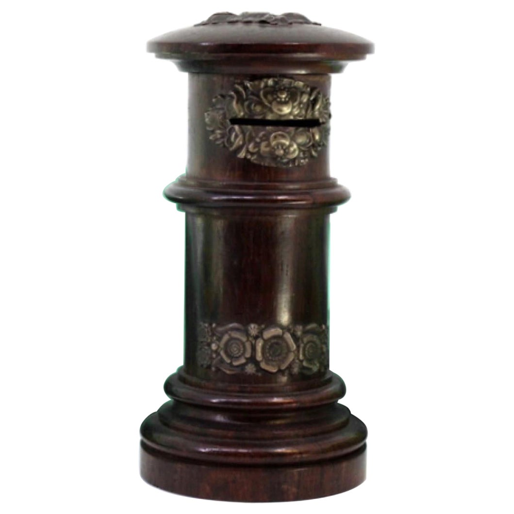 Piggy bank in rosewood shaped like a post box with silver applications