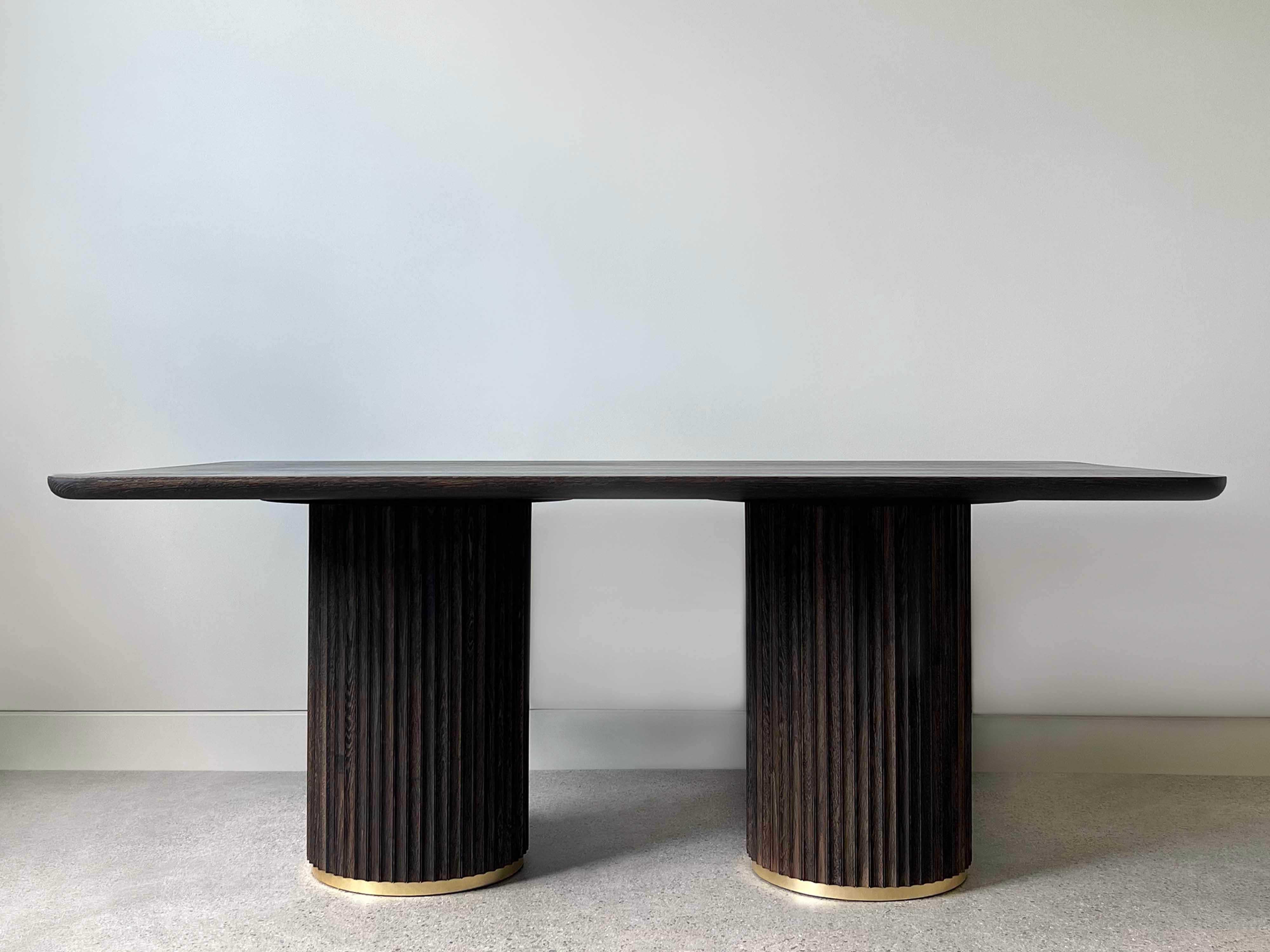 The Pilar Dining Table exudes a sense of subtle elegance and character in the space it inhabits. With a solid wood top and fluted double pedestal base, the table is plenty sturdy without looking heavy. The table seats six and has enough extra room