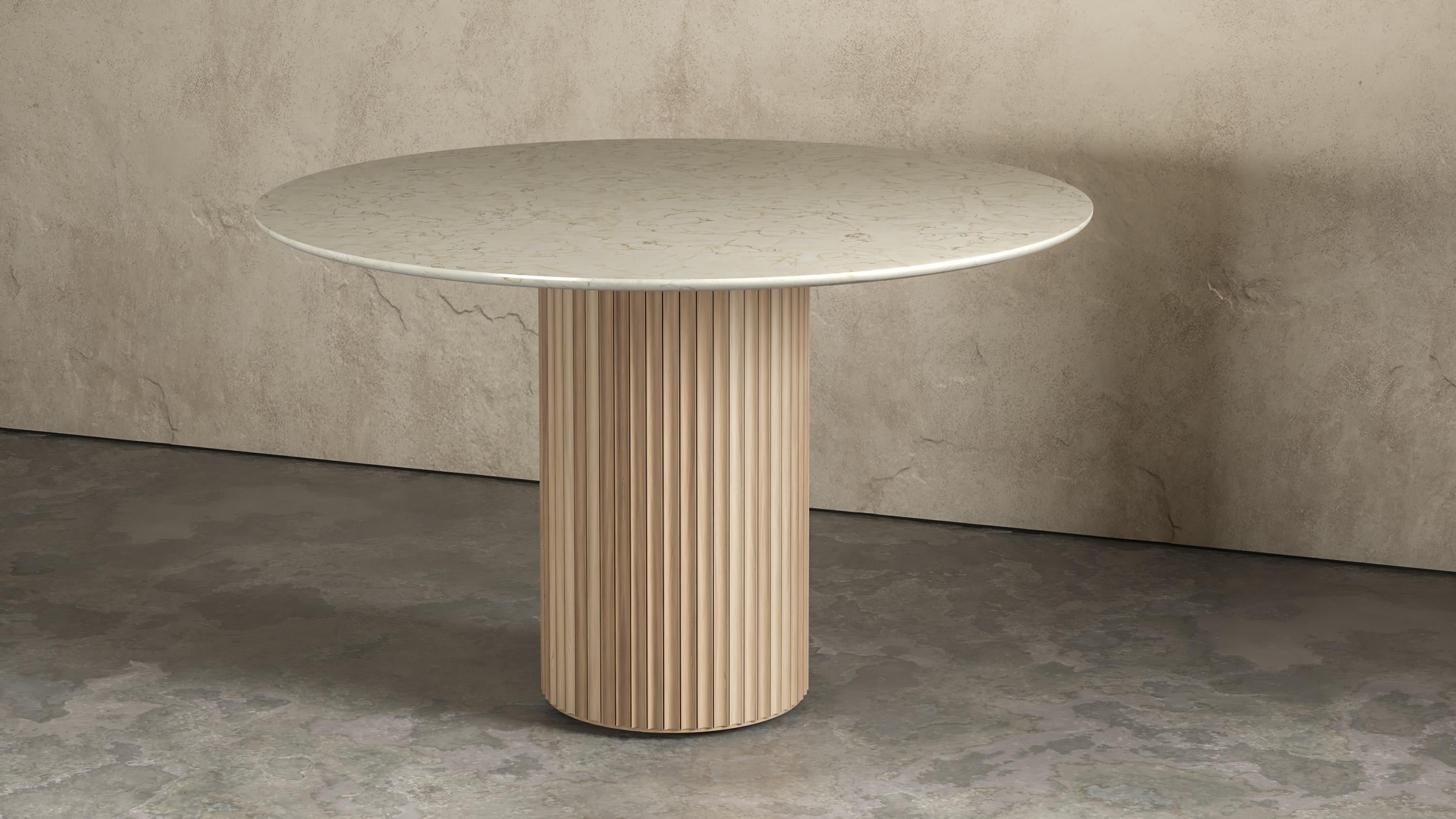 Pilar round white Oak dining table by Indo Made
One of a kind.
Dimensions: Ø122 X 76.2 cm 
Materials: Natural Oak, Crema Marfil Marble Top.

Also available in other materials and finishes. 
Each piece is carefully handcrafted by our team using