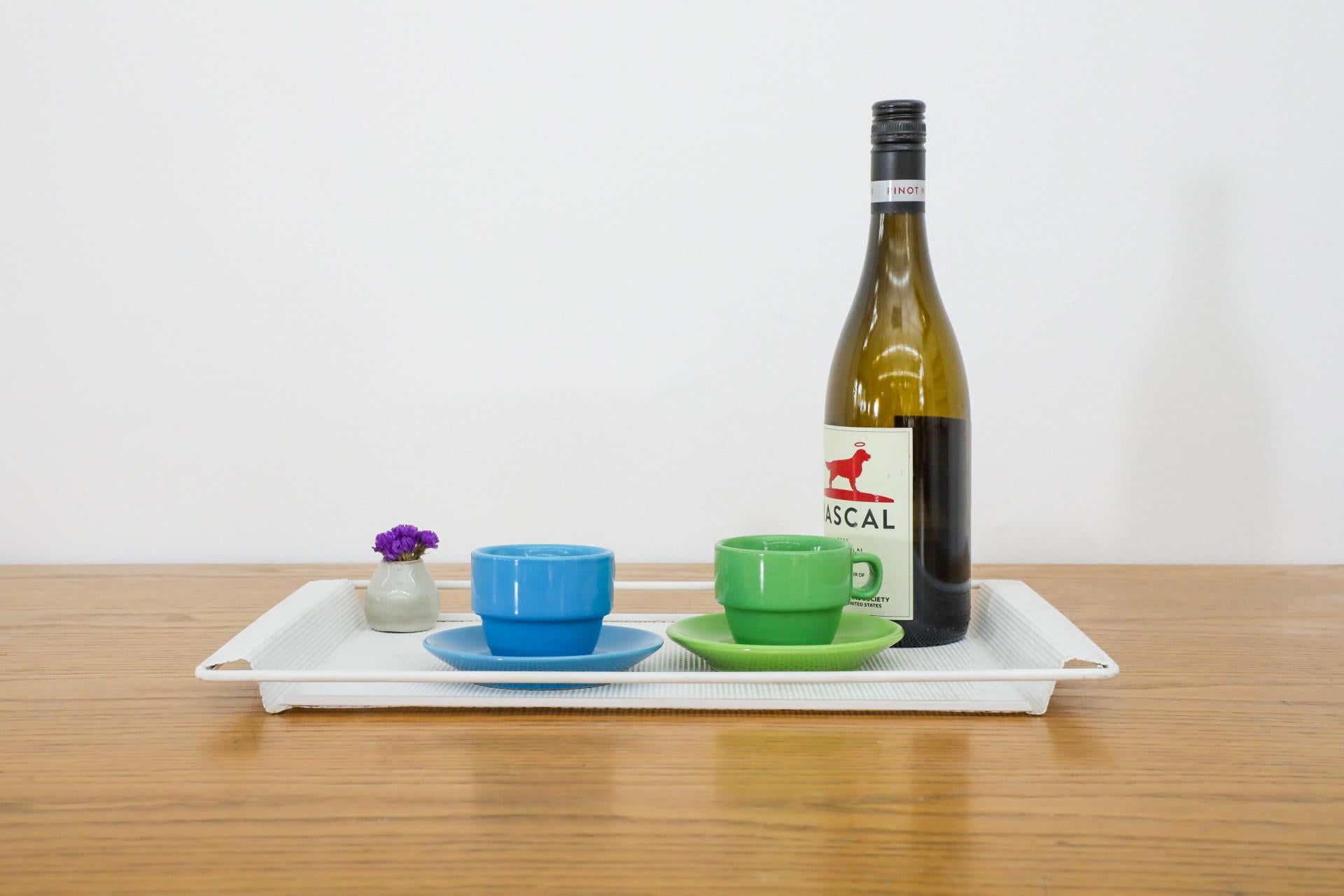 Mategot style white enameled perforated metal serving tray, attributed to Pilastro. In original condition with visible wear consistent with its age and use.