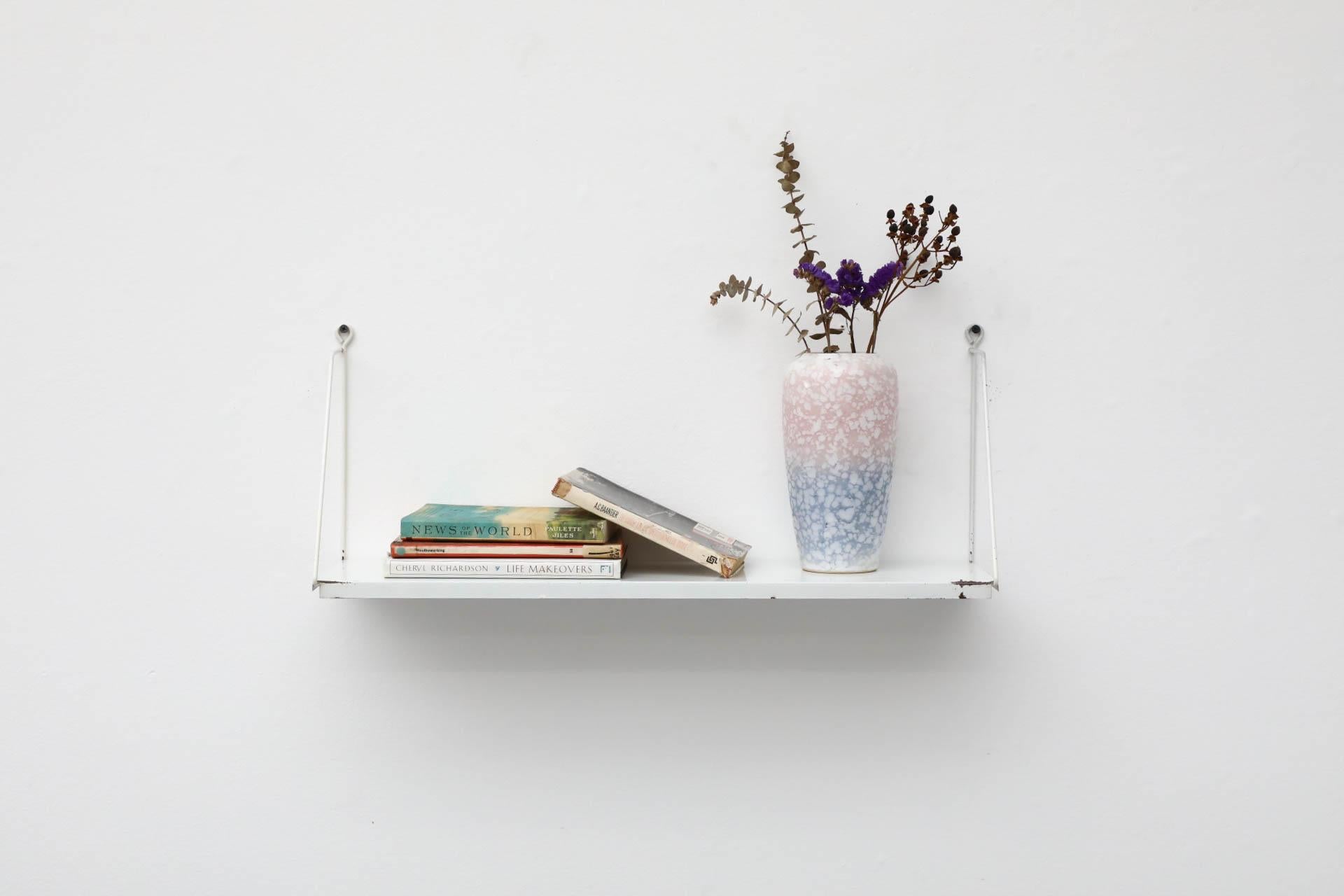 1960's Dutch Mid-Century, Pilastro attributed white enameled metal wall shelf in original condition some with some visible scratching and heavy enamel loss on the front and back corners. Well loved! Ships flat.
