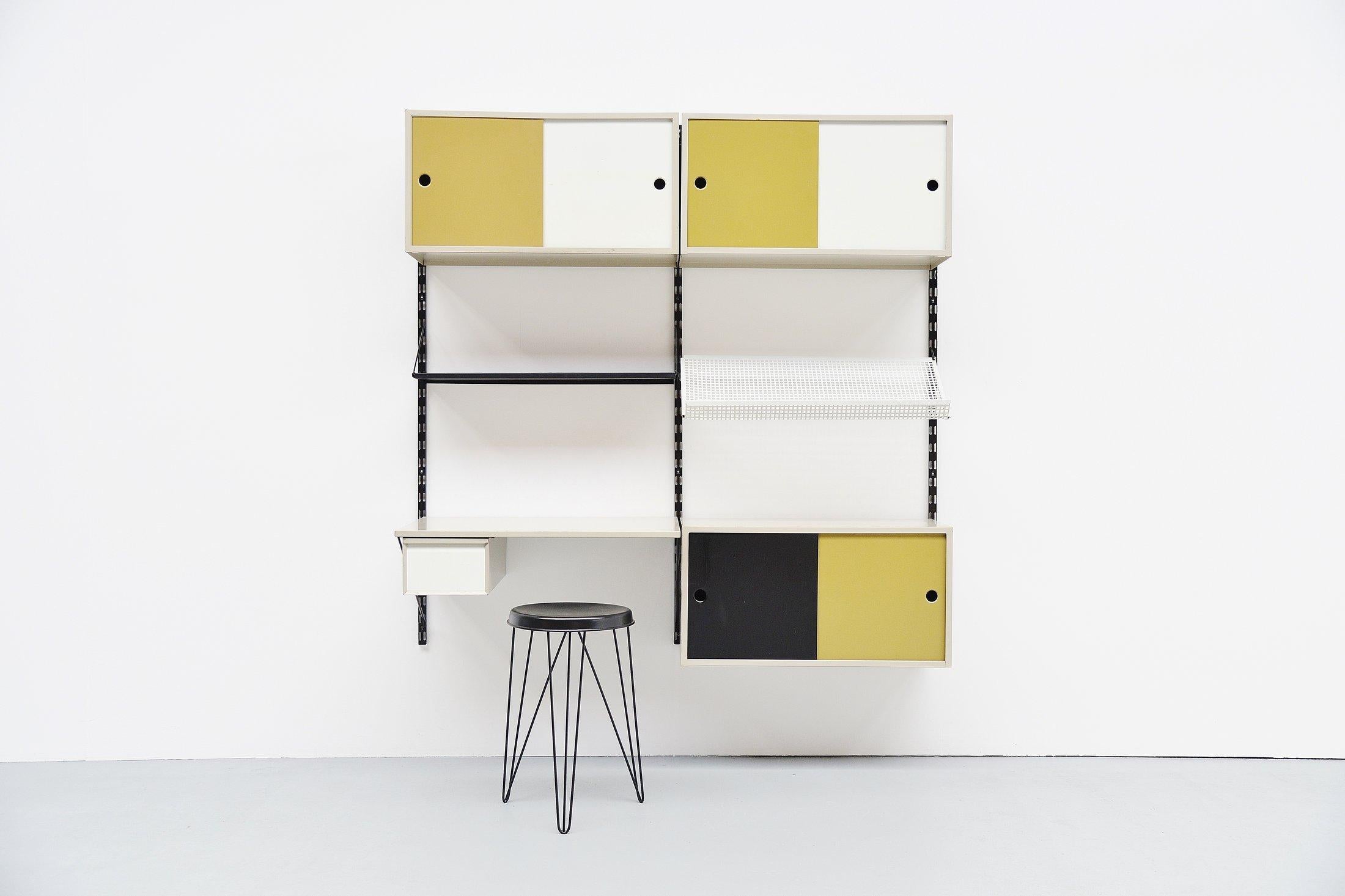 Very cool and complete shelving system / bookcase, designed by Tjerk Rijenga and manufactured by Pilastro, Holland 1960. This is a very nice medium sized and very complete wall unit with some nice options included. This unit contains some shelves, a