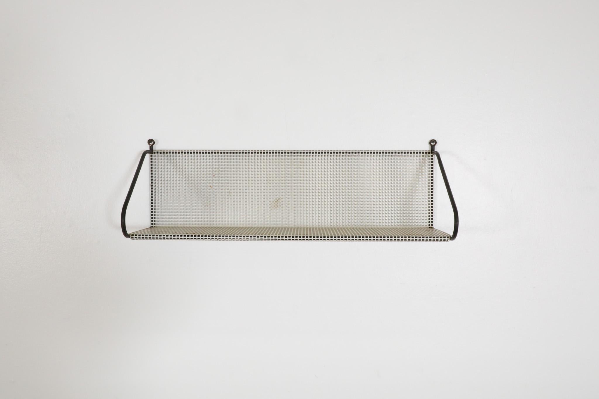 Mid-Century, Mathieu Mategot inspired, white perforated industrial wall mount shelf with contrasting black wire frame by Pilastro. Dutch designed, designer was most likely Floris Diedeldij who's very much acclaimed in his own right.  The shelf is in