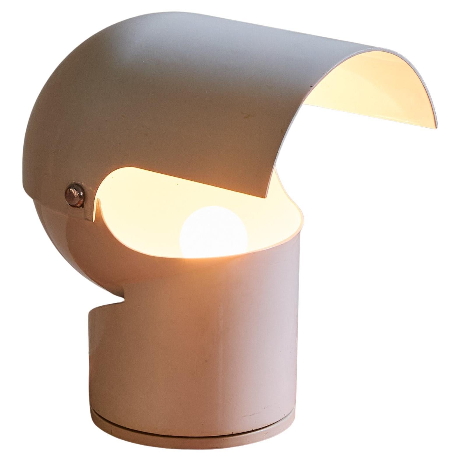 The ‘Pileino’ table lamp, designed by Gae Aulenti in 1972 for Artemide, is a rare space age classic. Crafted from white lacquered metal with a plastic base, this sculptural lamp has a rotating, adjustable metal shade that allows for dynamic light