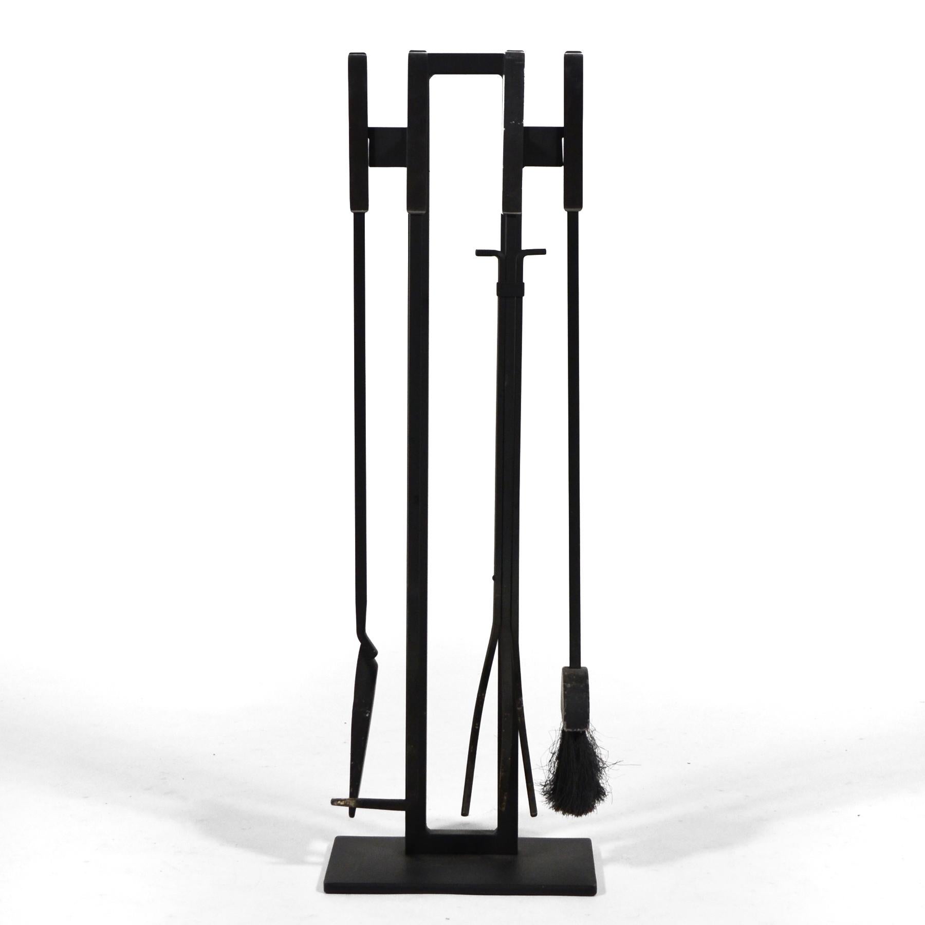 A wonderful architectural design by Pilgrim, this five piece set of iron fire tools features a poker, shovel, broom, and tongs, all with brushed steel handles and all of which are held by a stand.

Measures: 31
