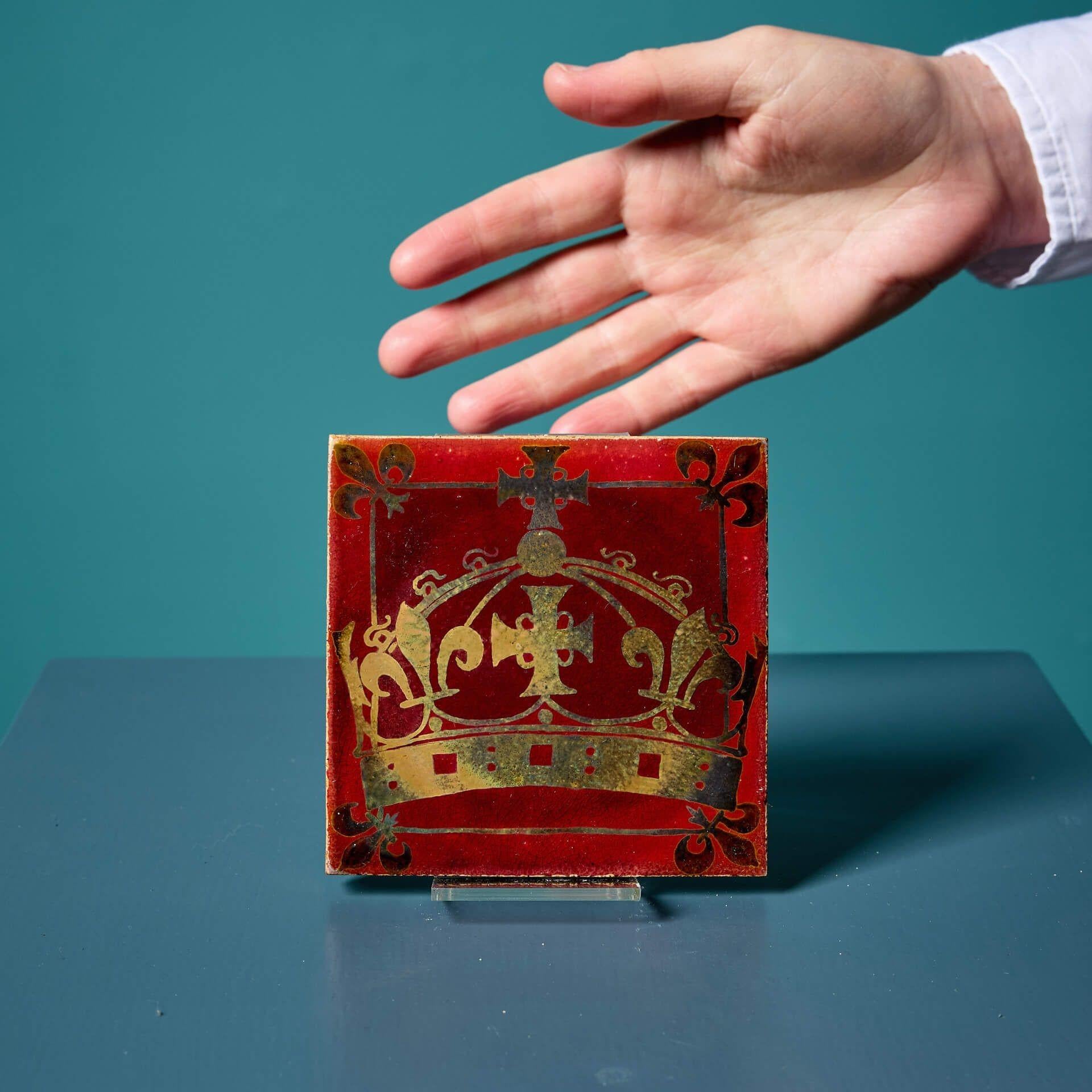 An excellent condition early 20th century 4-inch heraldic lustre tile attributed to Pilkington’s Tile and Pottery Co; one of two similar we have for sale.

This antique 4-inch collector’s tile is in exceptionally clean condition, detailing a gold