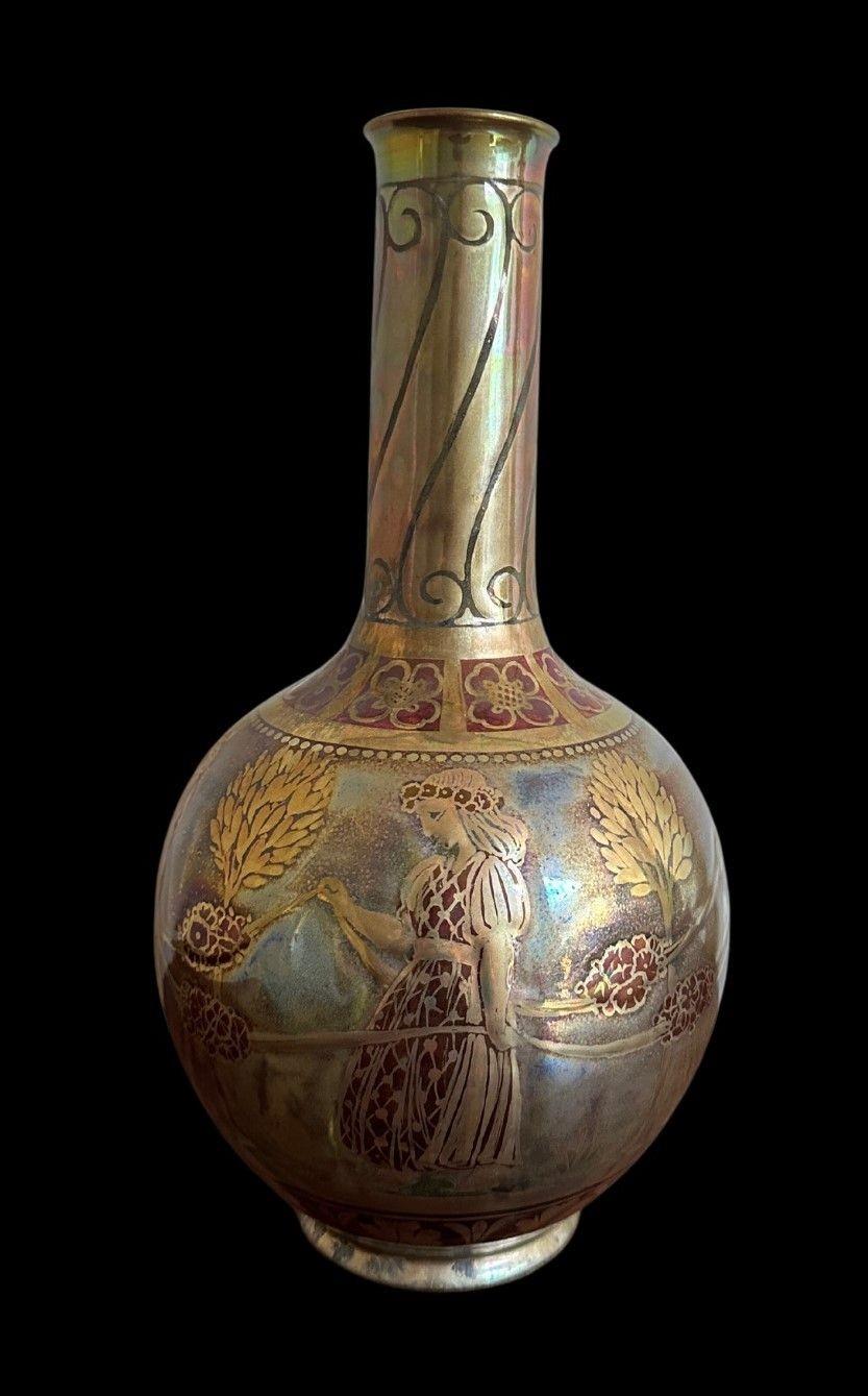 5399
Pilkington's Royal Lancastrian Lustre Globe and Shaft Vase décoré de vierges avec des guirlandes de roses par Richard Joyce
31 cm de haut, 16 cm de large
vers 1914.