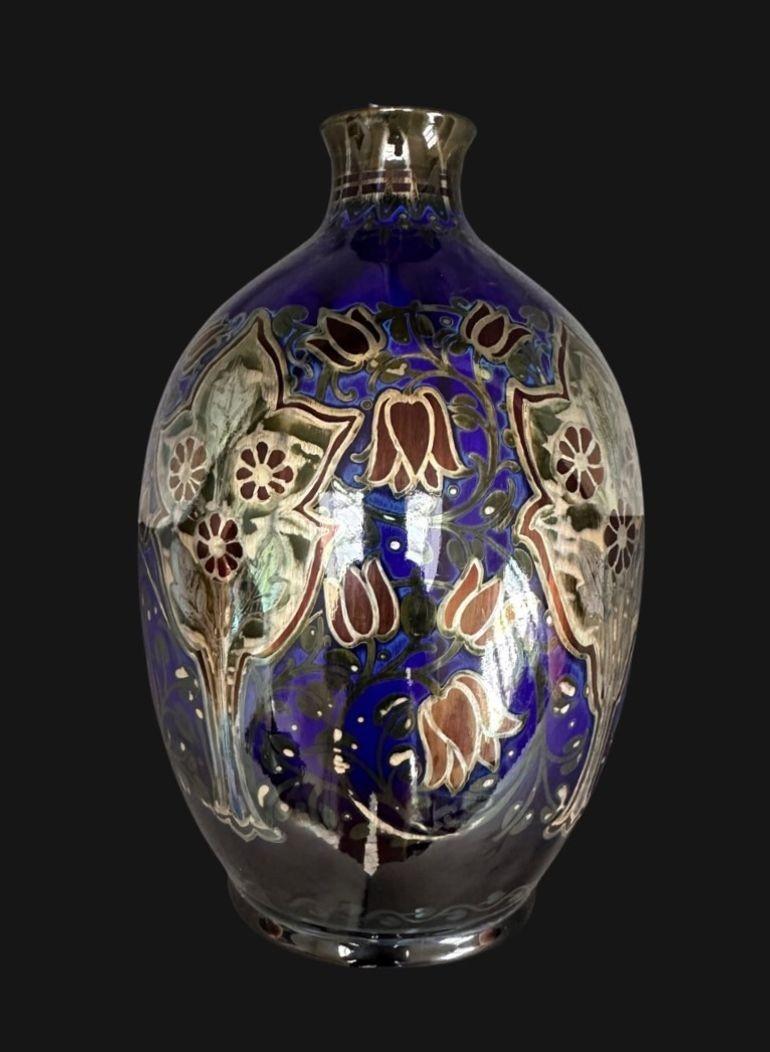 5435
Pilkington’s Royal Lancastrian Vase of Bulbous Form with an elegant neck, decorated with Floral Garnitures surrounded by Stylised Flowers by William Mycock
Dated 1922
22cm high, 13cm wide
