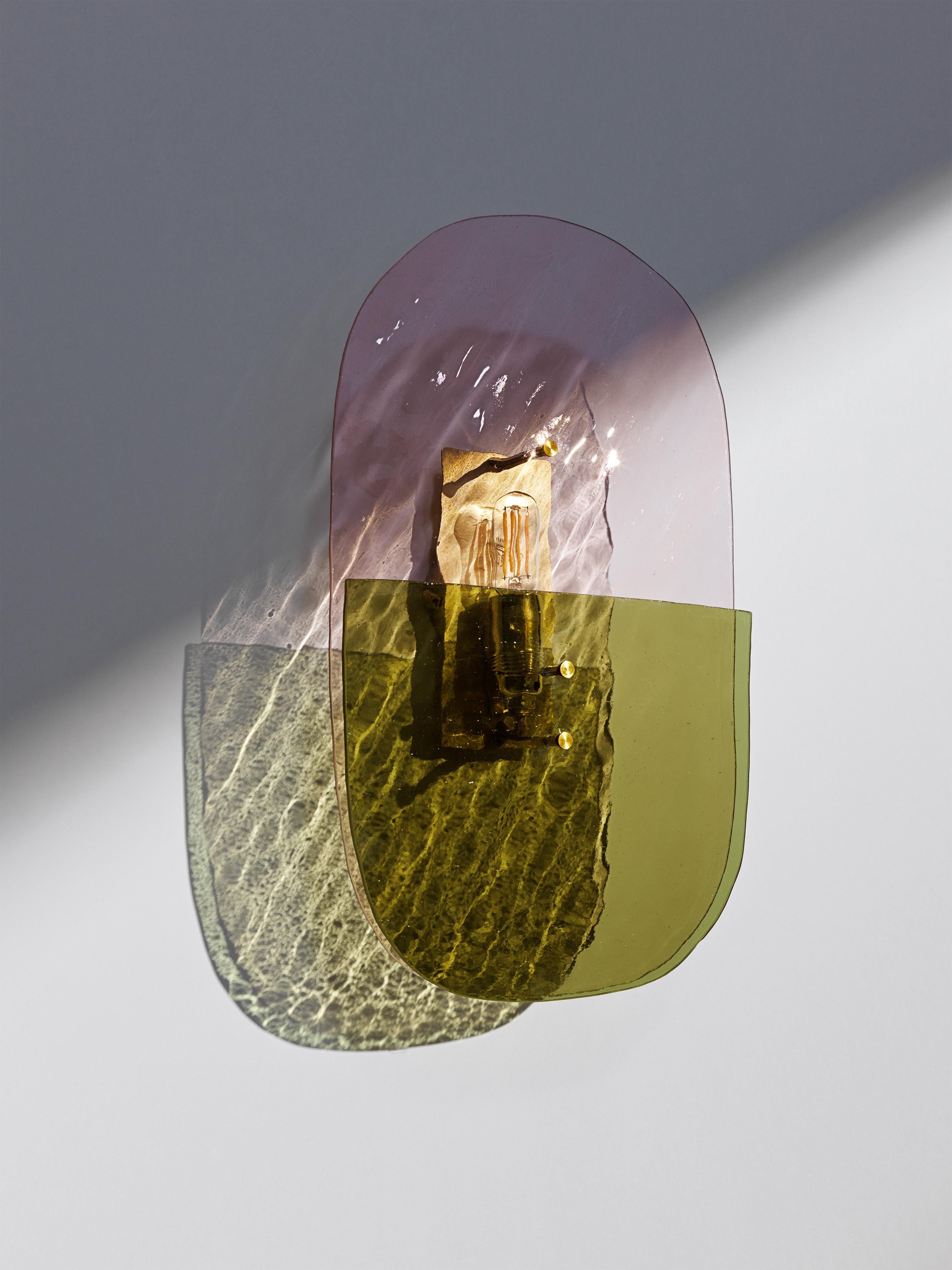 Pill 01 light sculpture by Marie Jeunet 
Dimensions: H 38.5 x L 22.5 cm
Materials: Champagne pink wave glass sheet, smooth olive green glass sheet, brushed brass structure and finish

LES PRECIEUX 
These luminous sculptures evolve with the