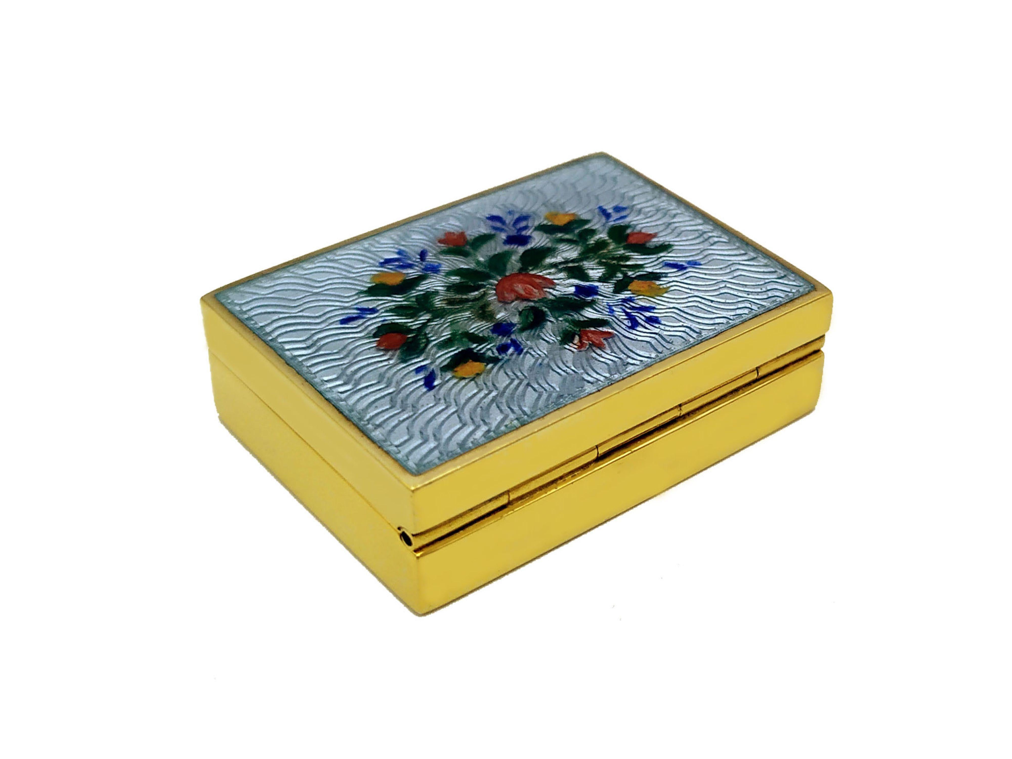 Rectangular pill box in 925/1000 sterling silver gold plated with translucent fired enamels on guilloche and hand painted floral miniature. Viennese Art Nouveau style. Size cm. 3 x 4 x 1,2. Weight gr. 42. Produced in Florence in the Salimbeni