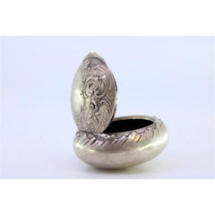 Pill box in embossed silver with hinged lid