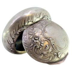 Pill box in embossed silver with hinged lid