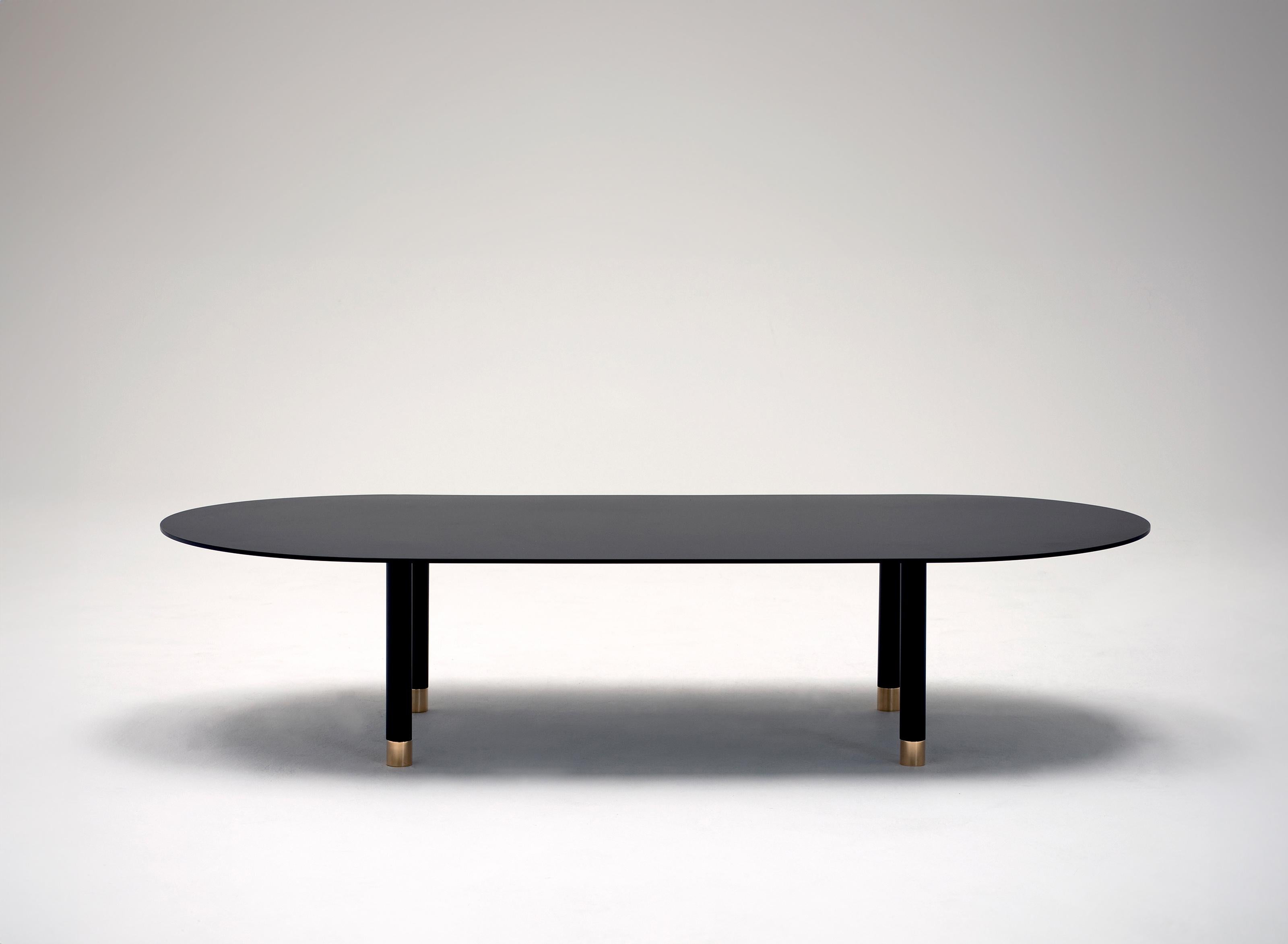 Pill Coffee Table by Phase Design
Dimensions: D 149.9 x W 71.1 x H 33 cm. 
Materials: Powder-coated steel and brass.

Powder-coated steel base with solid brass tips. Powder coat finishes are available in flat black, flat white, or flat gray. Prices