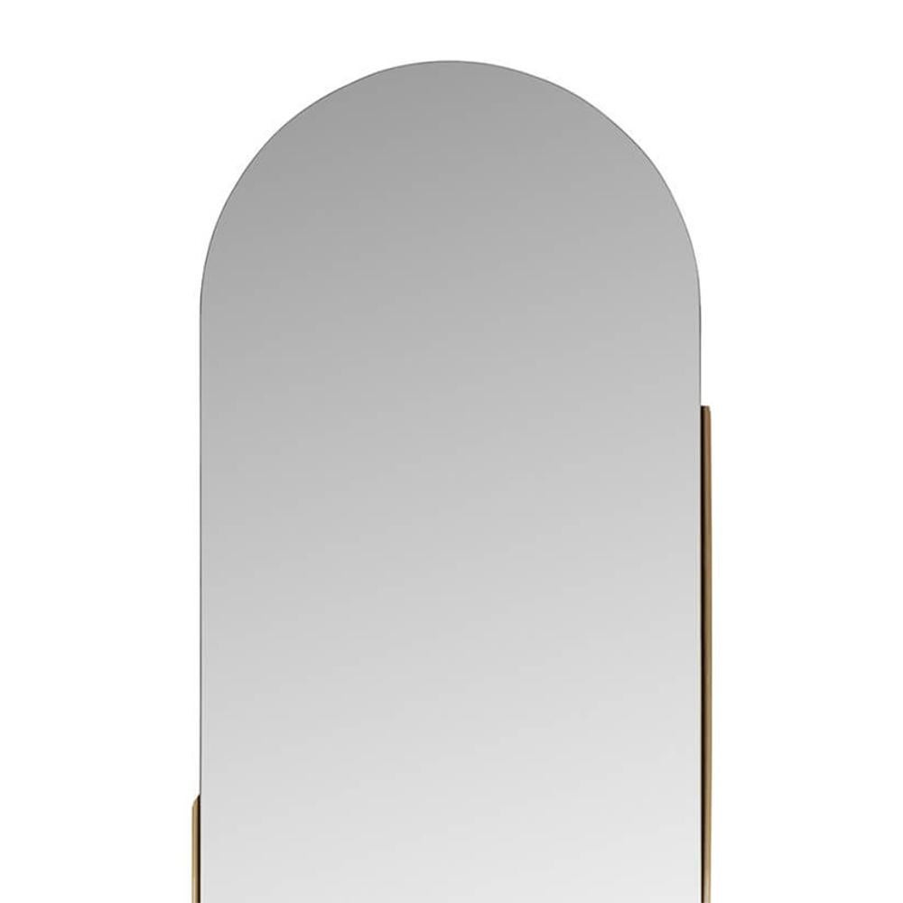 Pilule miroir avec structure métallique 
en finition laiton. Avec verre miroir transparent. 
 