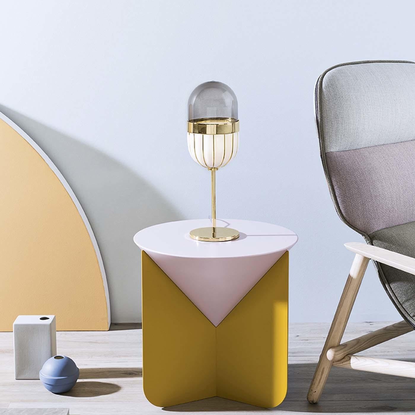 Part of the Pill collection designed by Matteo Zorzenoni, this elegant and modern table lamp will be a sophisticated addition to a desk or console and can be paired with the floor lamp and ceiling lamp in the same series for a cohesive effect. The