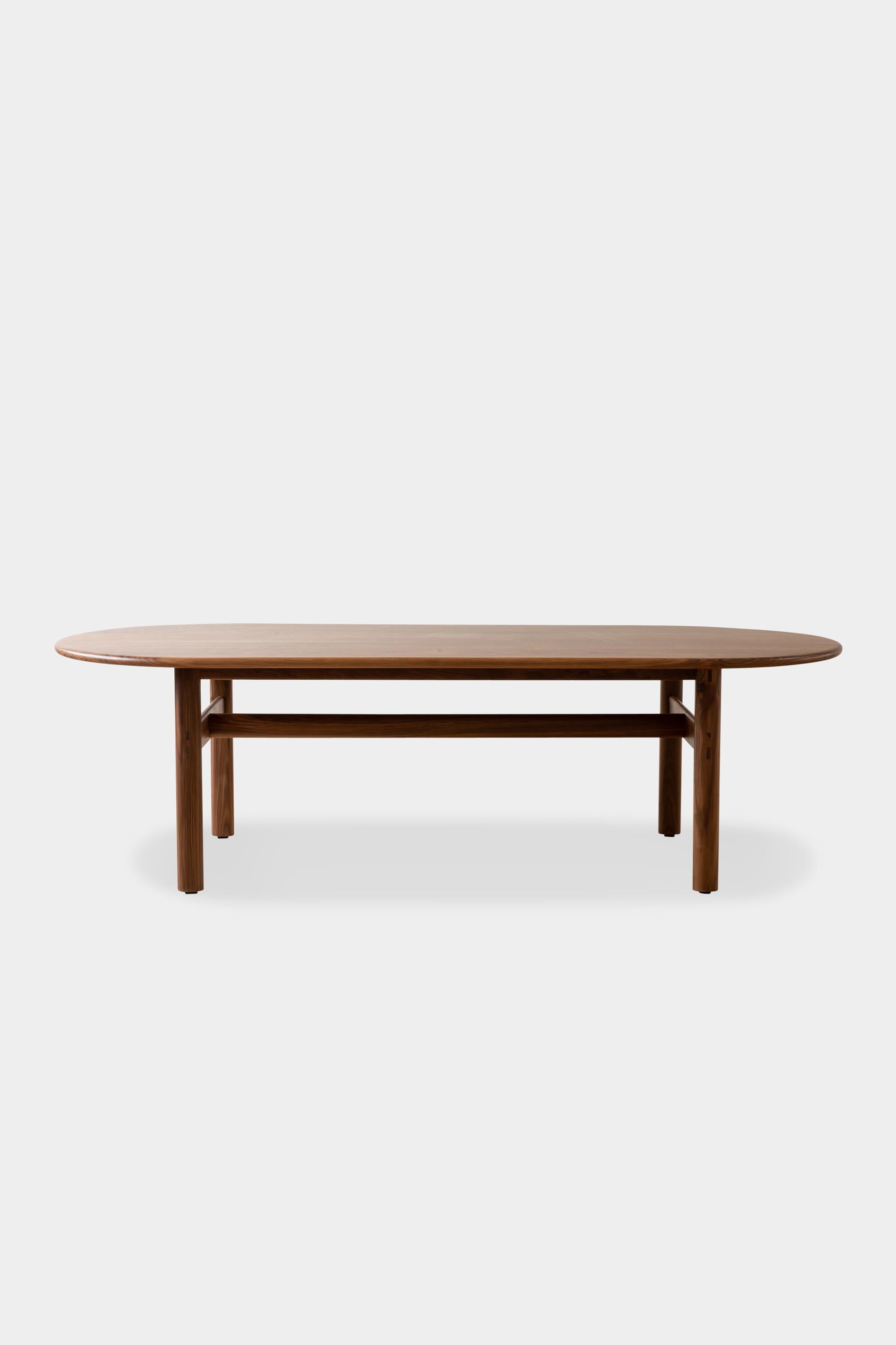 Handmade dining table with a simple trestle base. Solid wood tops feature individualized dutchman joints and unique orientations to accentuate and utilize the natural characteristics of each batch of lumber we source. This table is available in any