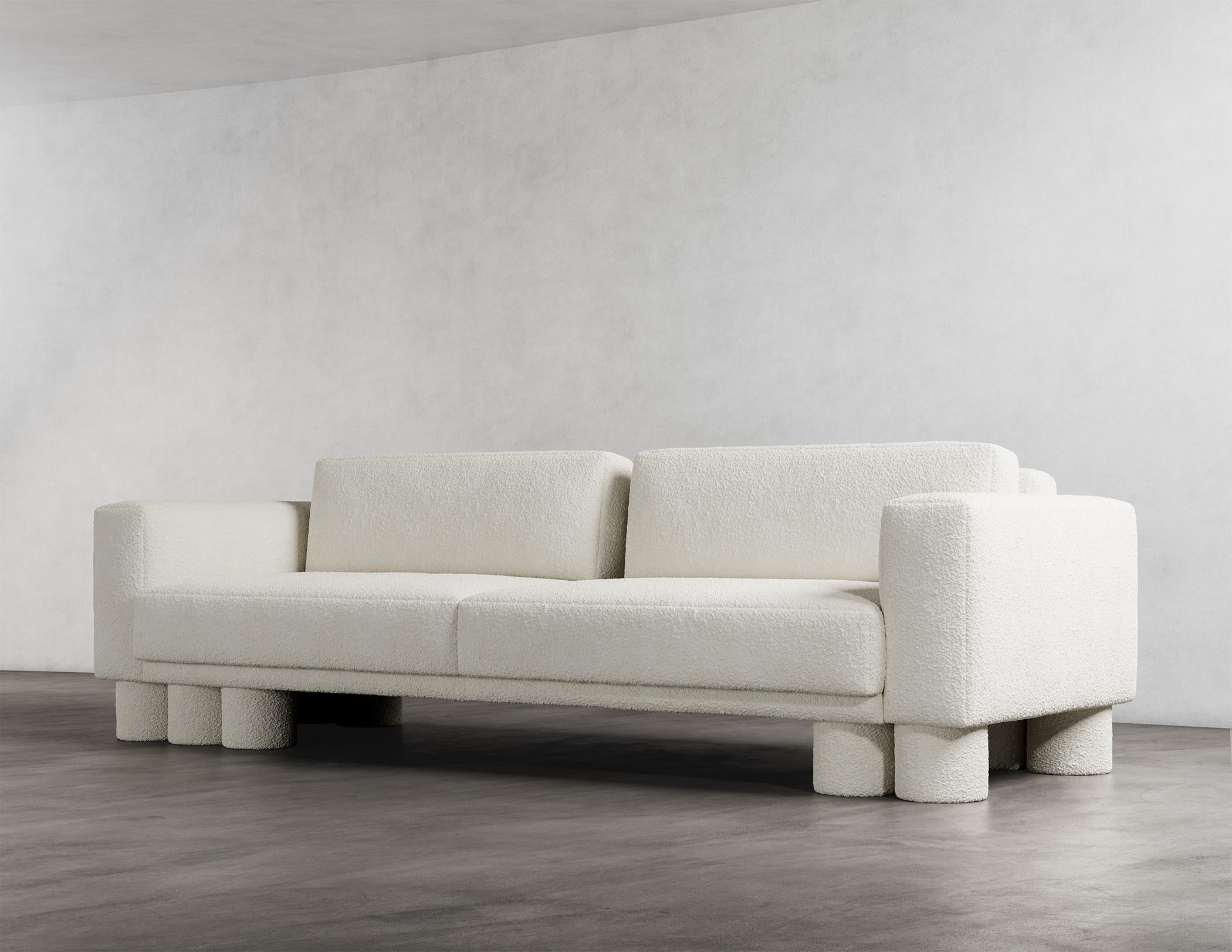 The Pillar Sectional Sofa is a stunning piece of furniture with a unique and captivating design. It is characterized by layered, asymmetrical design elements that create a sense of sophistication and simplicity. The deliberate imbalance in these