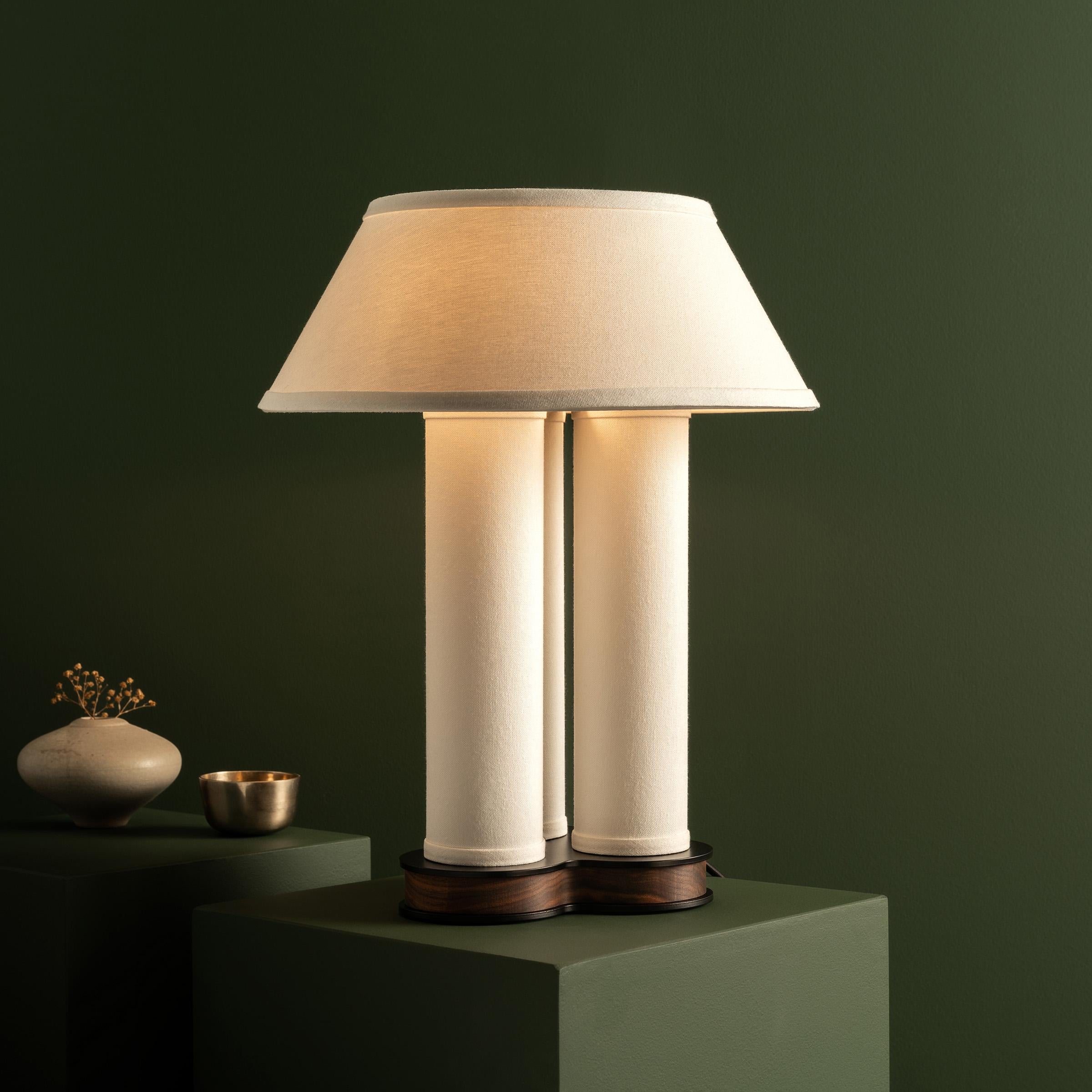 Our clover-shaped table lamp compels attention with both organic flow and precise symmetry. The gracefully curved design features a touch-sensitive switch for easy on/off. The optional diffusor softens the light above, while the three-column shade