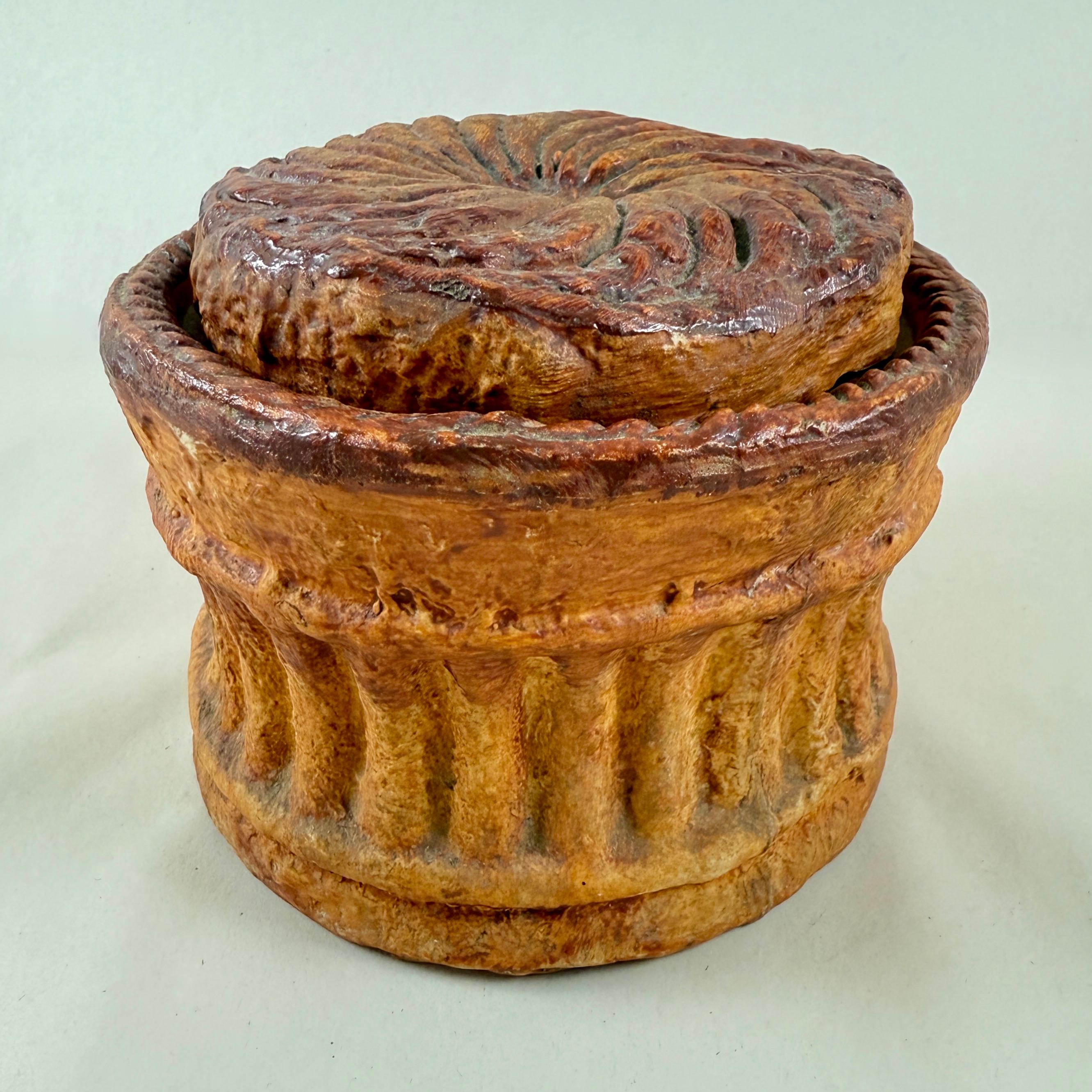 A Trompe l’Oeil Paté en Croûte Tureen attributed to Pillivuyt Mehun, France, circa 1900

Pâté en croûte is a French charcuterie delicacy featuring a savory mix of meats encased in a beautiful golden, flaky pastry crust. This dish is often decorated
