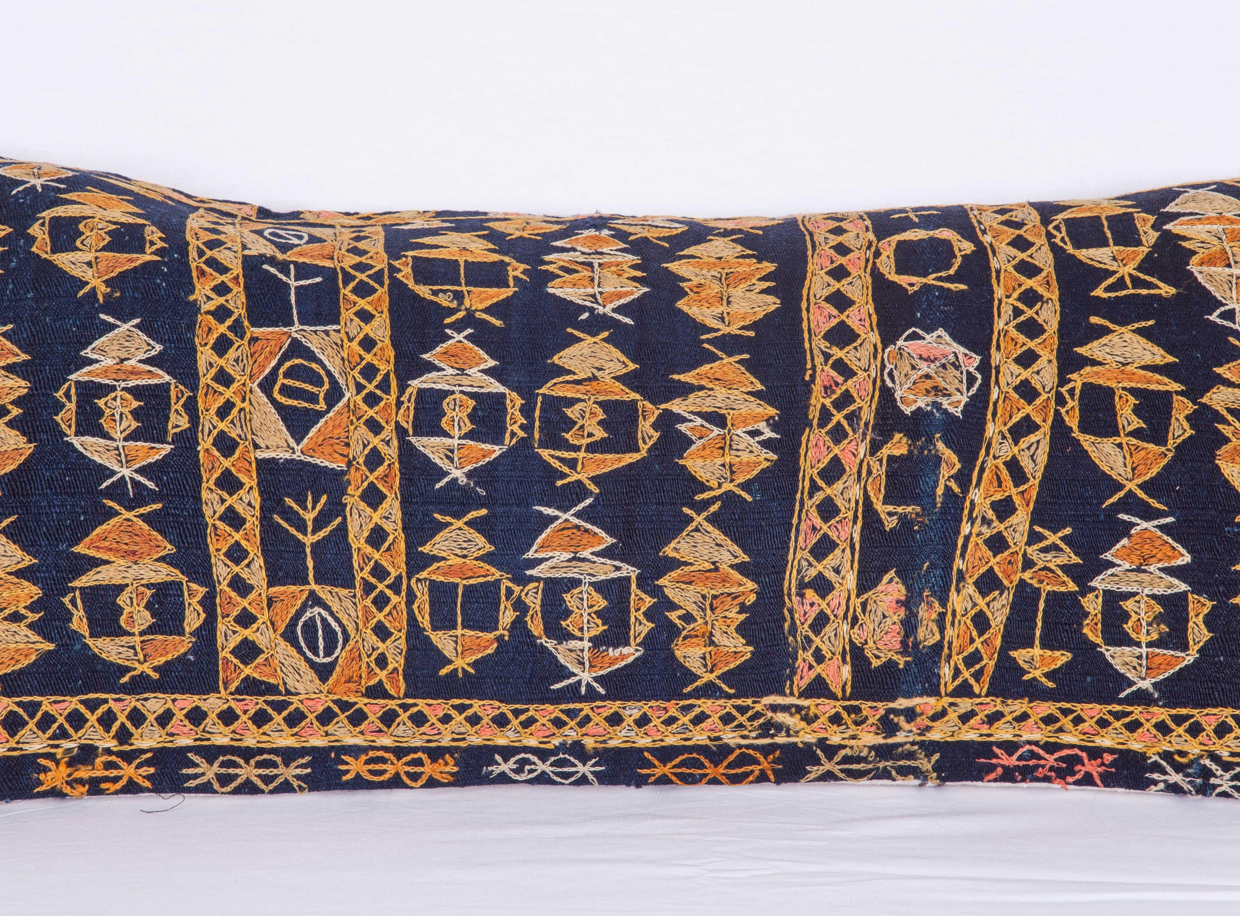 Pillow case made from an antique Kurdish Kilim with indigo color background. It does not come with an insert but it comes with a bag made to the size and out of cotton to accommodate the filling. The backing is made of linen. Please note 'filling is