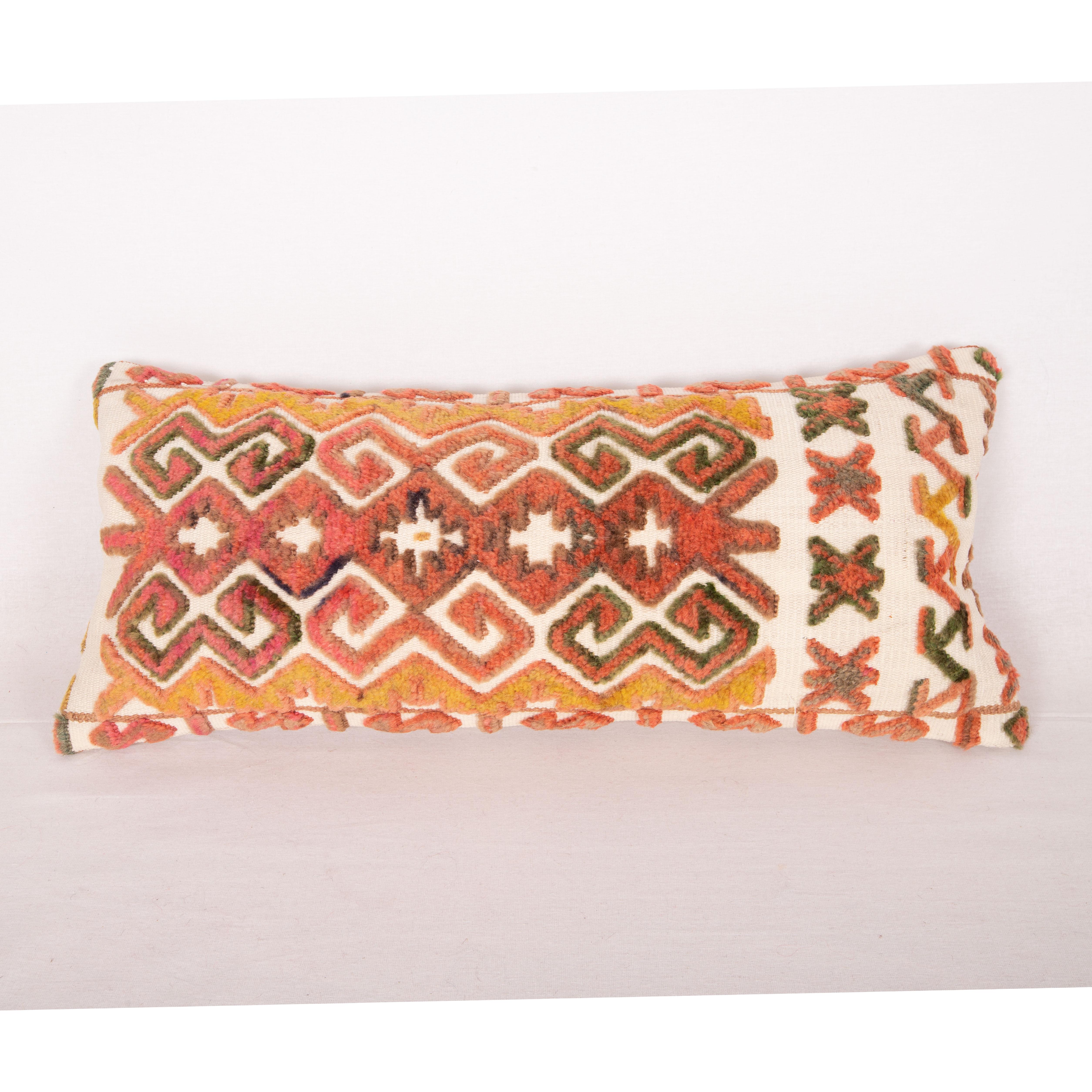 Tent bands are done almost by all the tribes of Turkmen peoples of Central Asia. They functioned as decorative hangings around their dwelling called Yurt. This very pillow is made from a Karakalpak one. 
It does not come with an insert but a bag