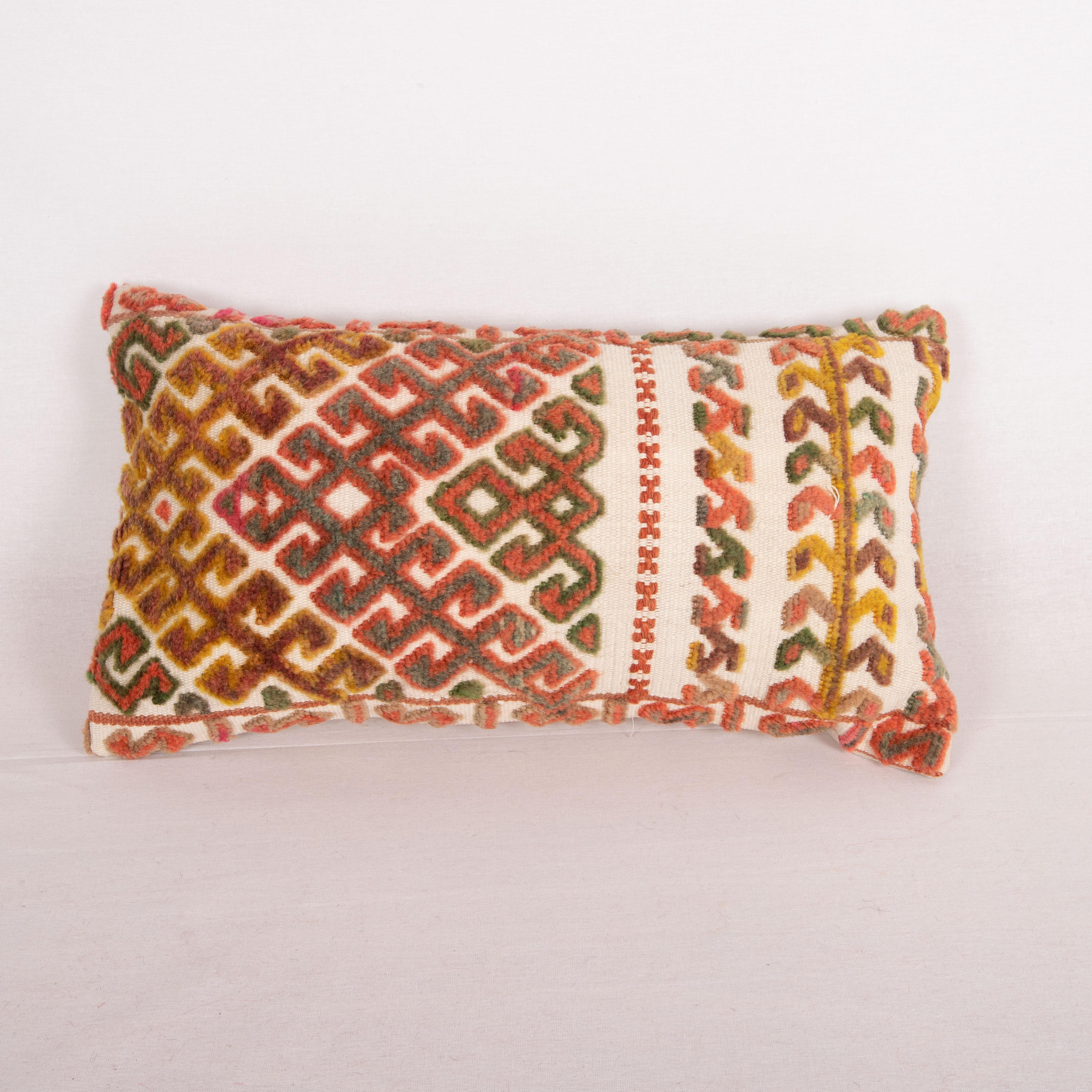 Tent bands are done almost by all the tribes of Turkmen peoples of Central Asia. They functioned as decorative hangings around their dwelling called Yurt. This very pillow is made from a Karakalpak one. 
It does not come with an insert but a bag