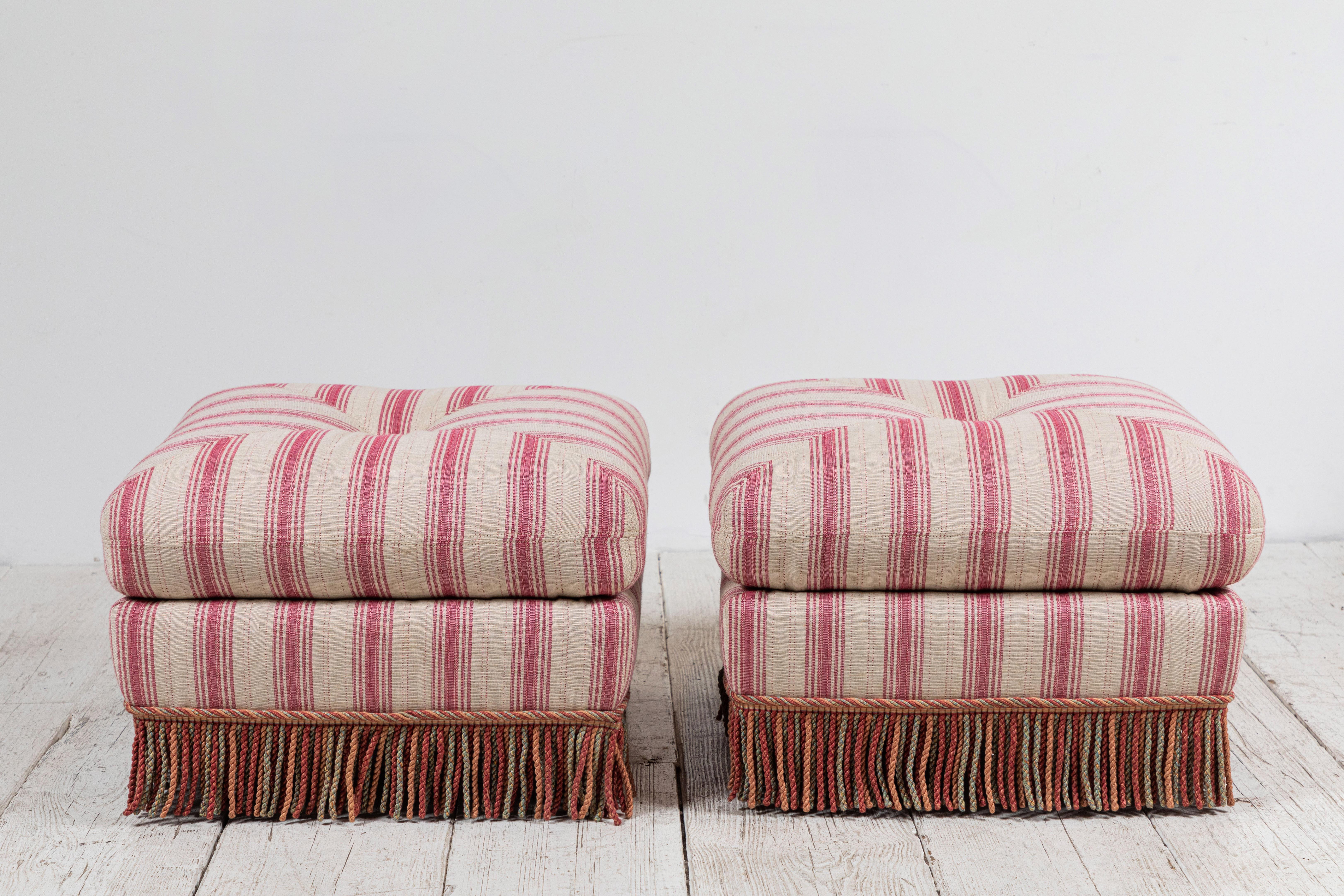 French pillow ottomans newly upholstered in Susan Deliss pink and natural striped fabric, bottom fringe is original.