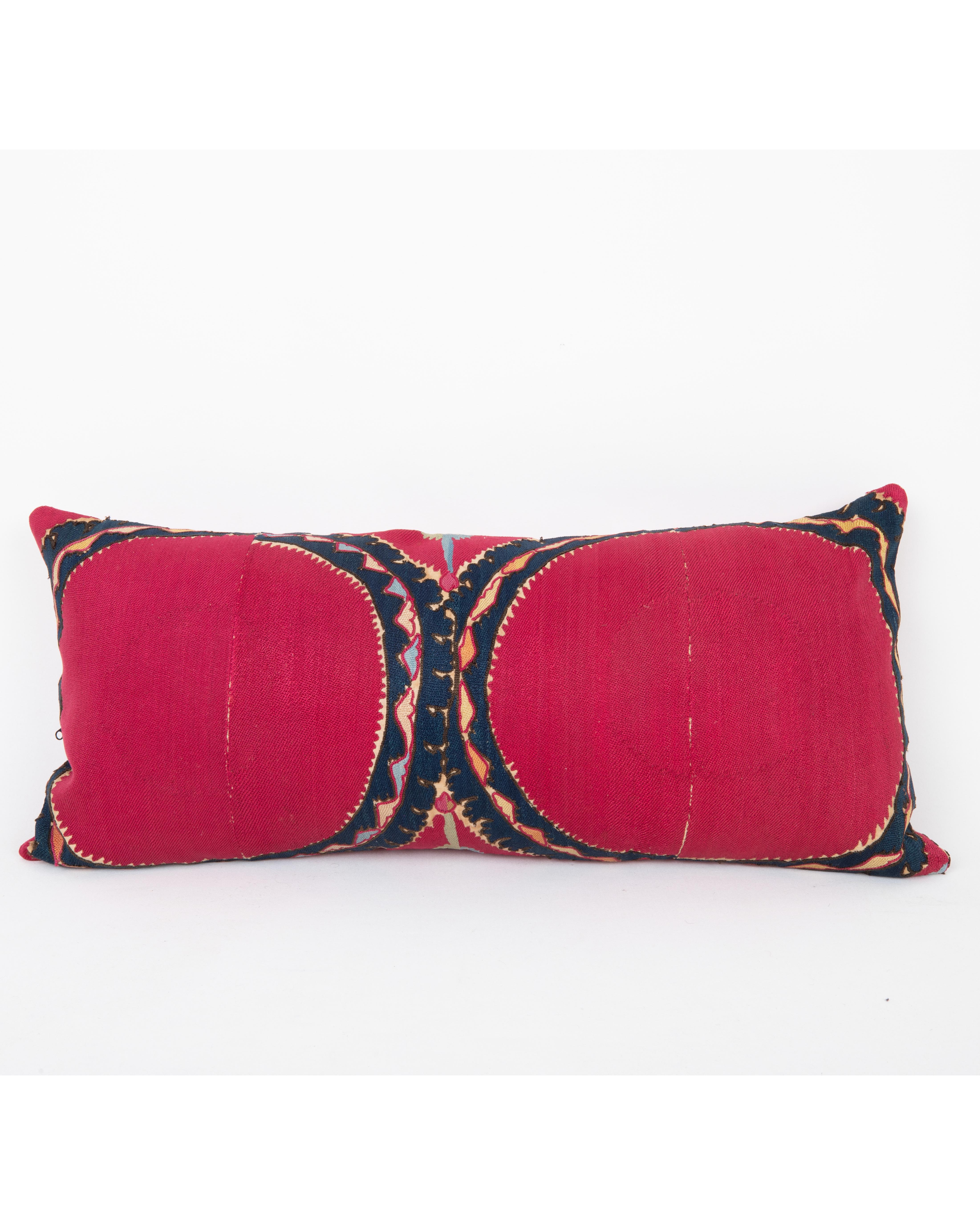 It does not come with an insert.
Linen in the back.
Zipper Closure.
Dry Cleaning recommended.

This  pillow has been fashioned from an antique Tashkent suzani, distinguished by its deep red ground and the classic “Ai Palak” (Moon Sky) motif — a