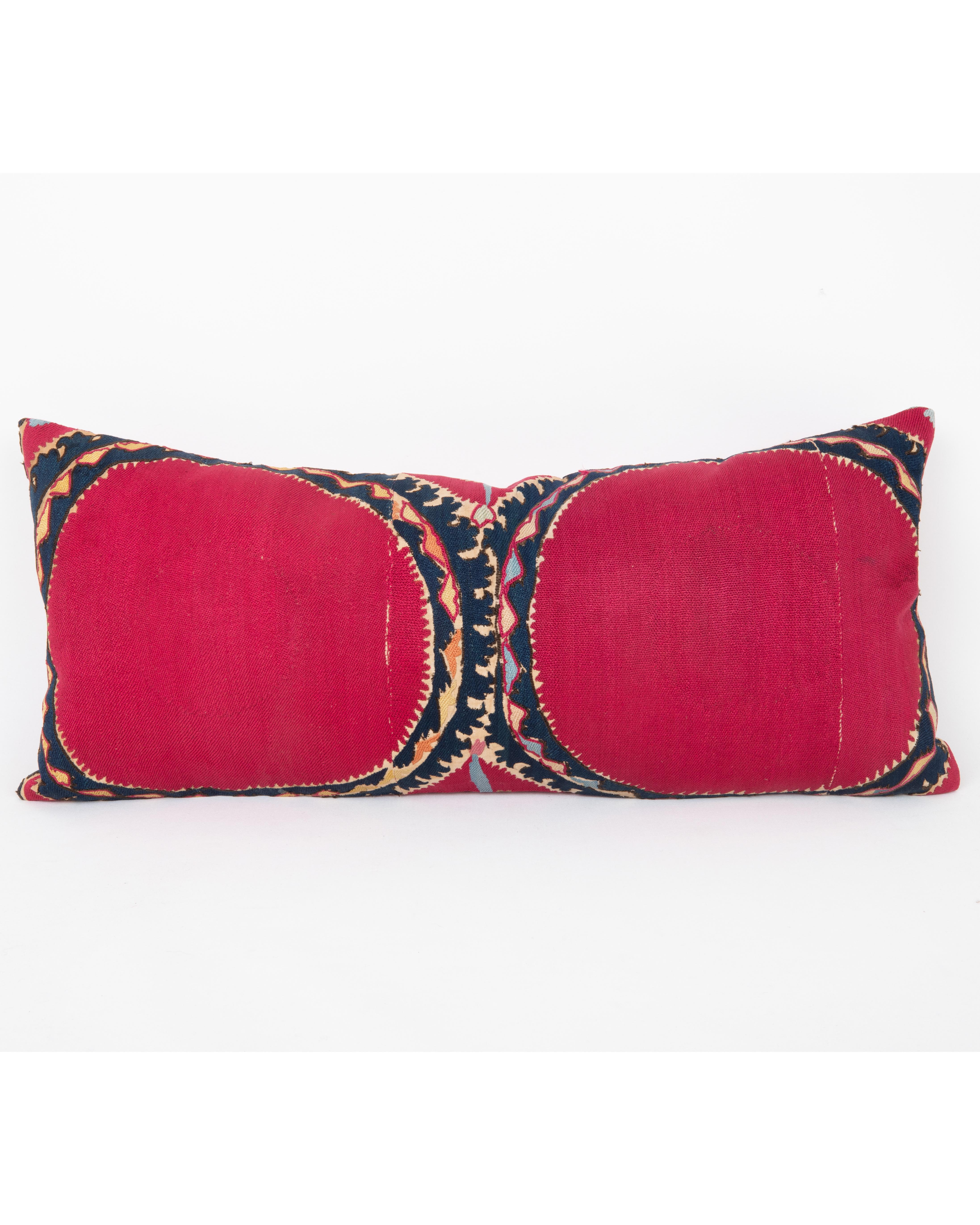 It does not come with an insert.
Linen in the back.
Zipper Closure.
Dry Cleaning recommended.

This  pillow has been fashioned from an antique Tashkent suzani, distinguished by its deep red ground and the classic “Ai Palak” (Moon Sky) motif — a