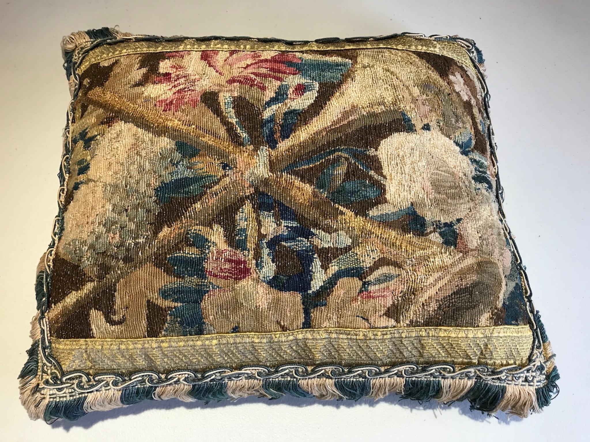 A pair of pillows made from fragments of fine mid-17th century Brussels tapestry depicting fruit and flowers. Faced with gold braid and a two tone silk fringe. i am asking £3,000 for the pair

Measures: length 34cm
Height 39cm
Depth 11cm
Fringe