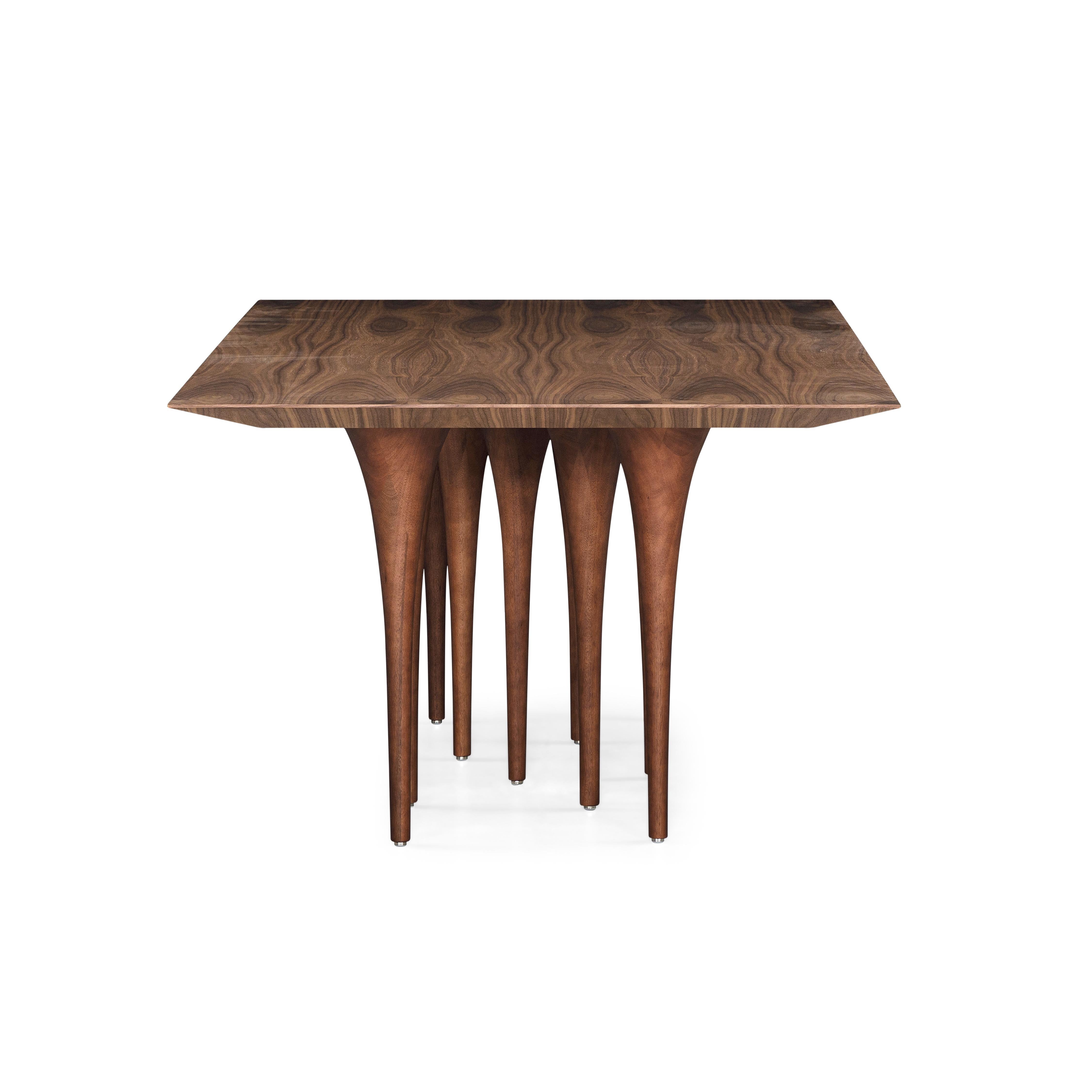 The Uultis team has created this rectangular Pin table in a walnut wood finish with ten legs causing a surprising impact at first sight. It has a very singular and original structure resembling the corridors of Gothic castles, but at the same time,