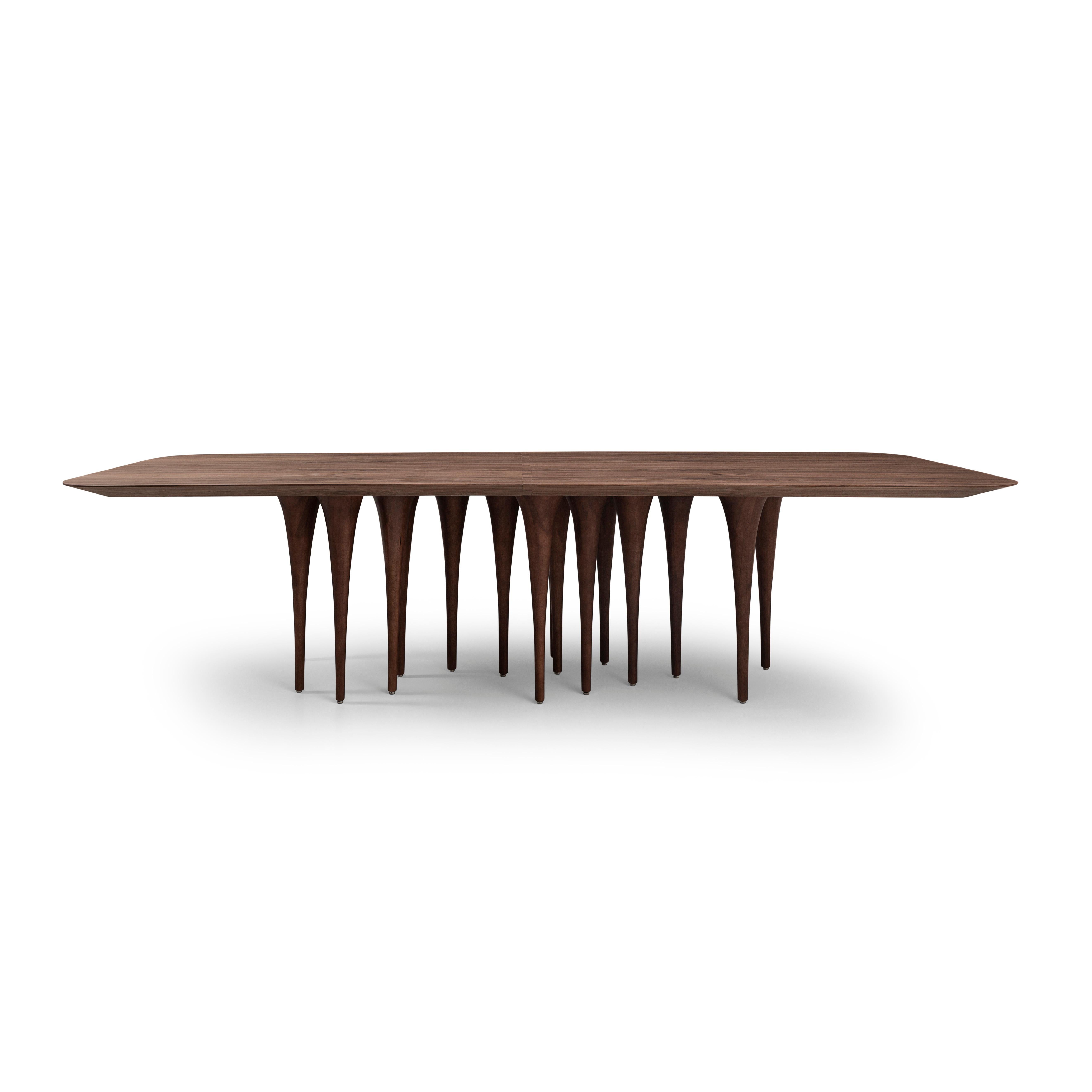 The Uultis team has created this rectangular Pin table in a walnut wood finish with twelve legs causing a surprising impact at first sight. It has a very singular and original structure resembling the corridors of Gothic castles, but at the same
