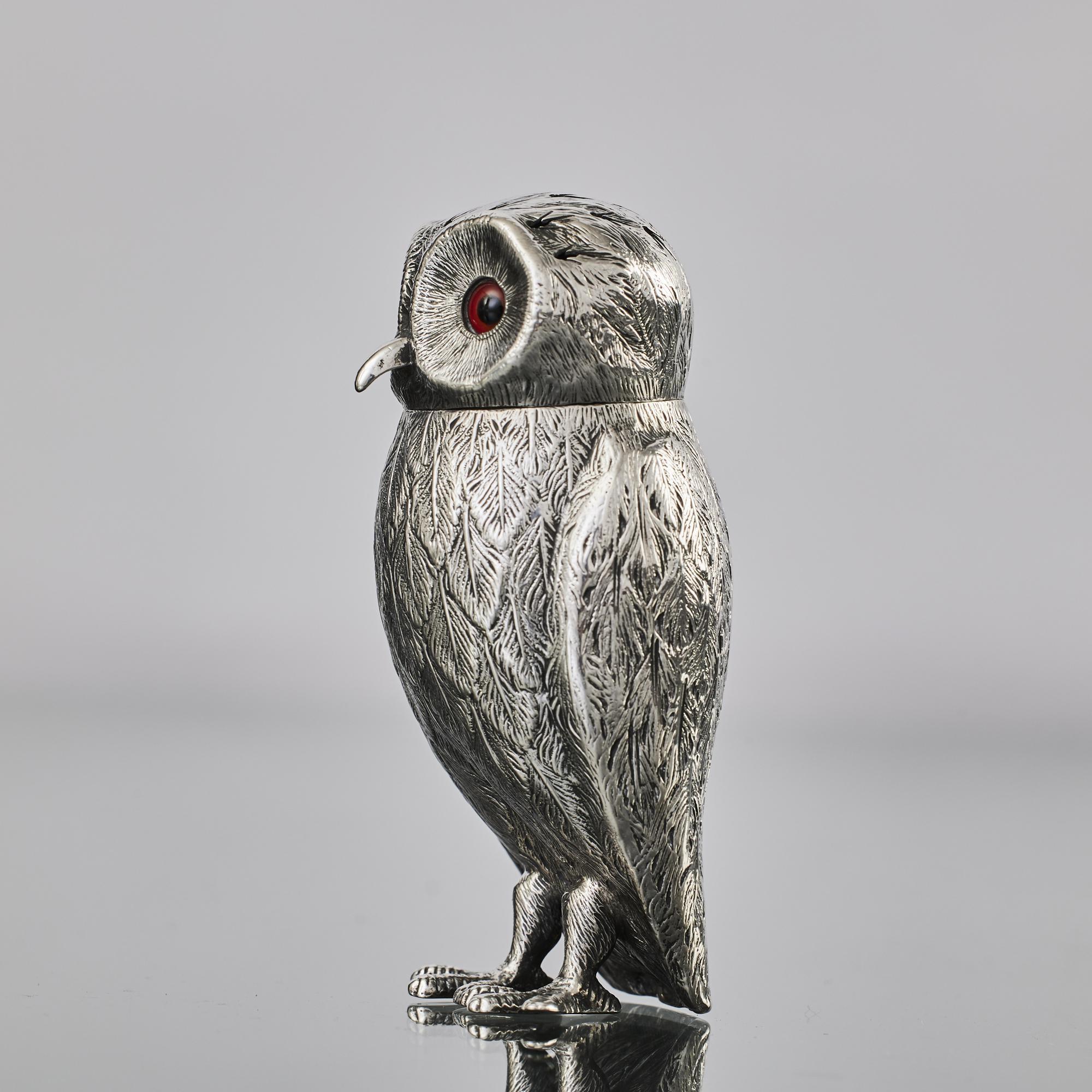 Large, Victorian-era, antique silver pepper caster in the form of an owl. This charming fellow has inset glass eyes and a hand-pierced head to shake the pepper through. 
 
 The interior is gilded so could be alternatively used as a pepper shaker,