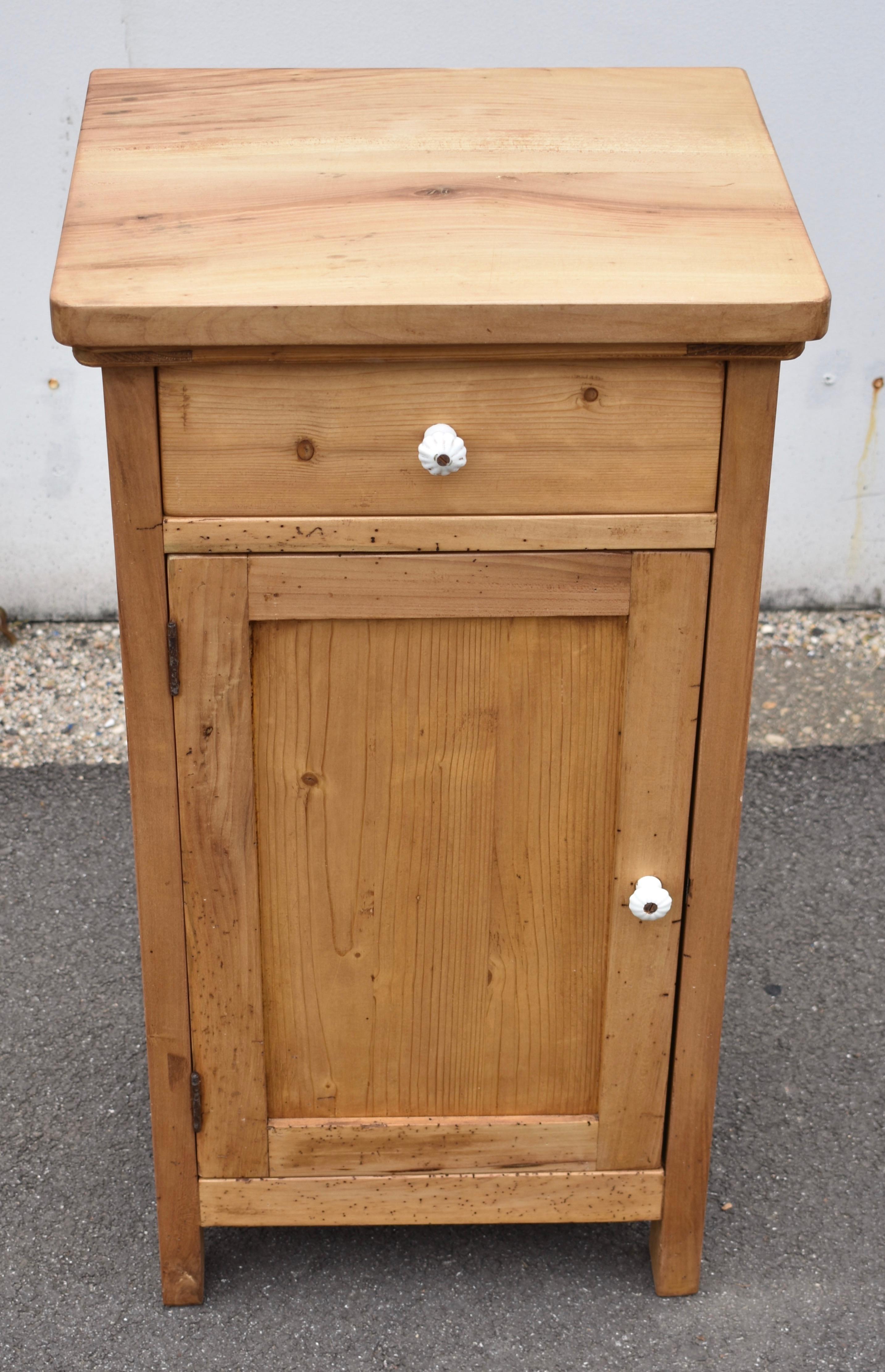 This is an attractive mixed wood nightstand.  The thick top and the frame are beech and the panels and drawer front are pine.  The contrast in wood species works well with the clean straight lines of the cupboard.  There is a single shelf in the
