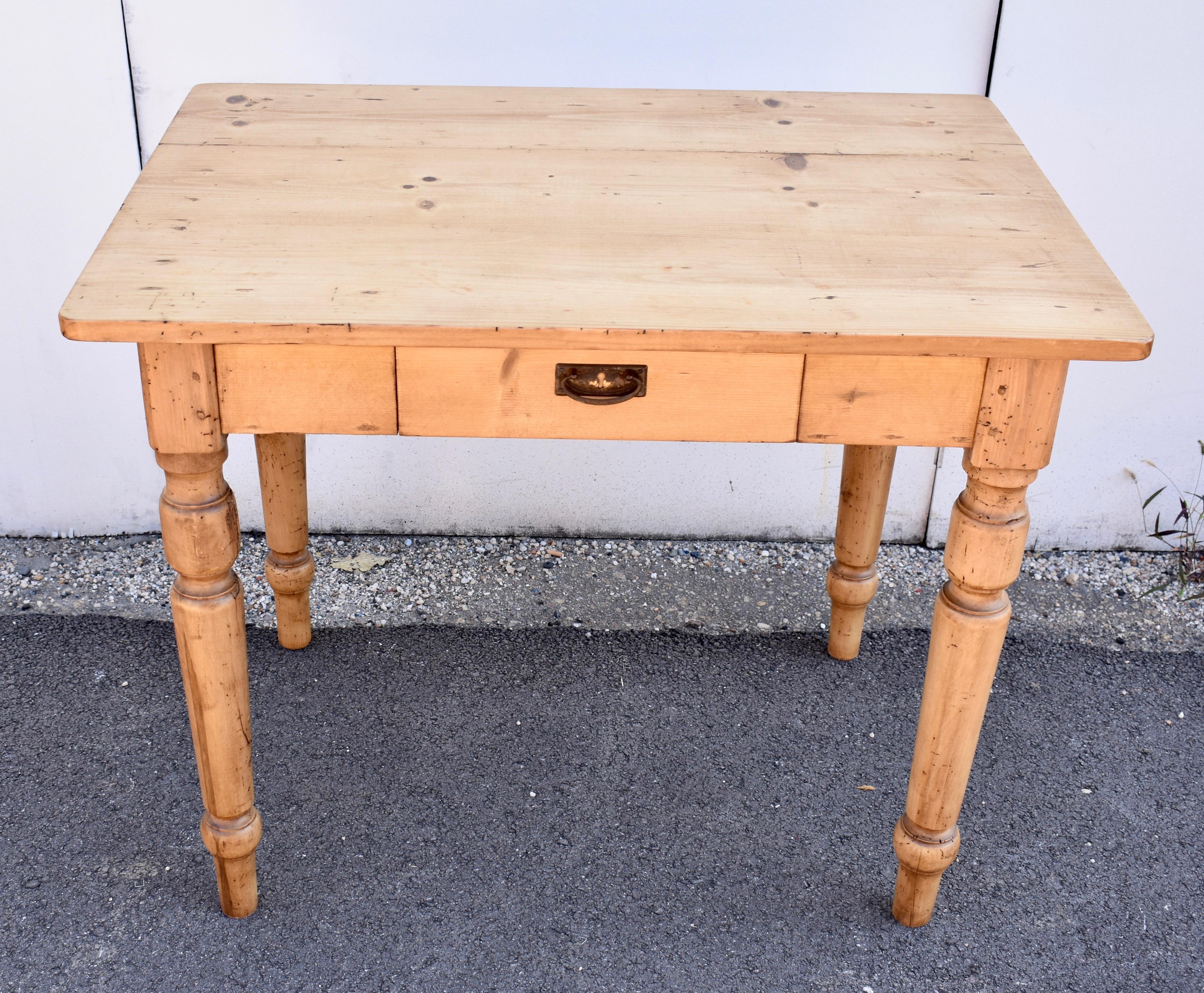 This versatile Pine and Beech writing table is as “at home” in a small kitchen as it is in the office or student bedroom.  The top is extremely attractive.  The front apron houses a full-depth drawer for pencils and other office materials. 