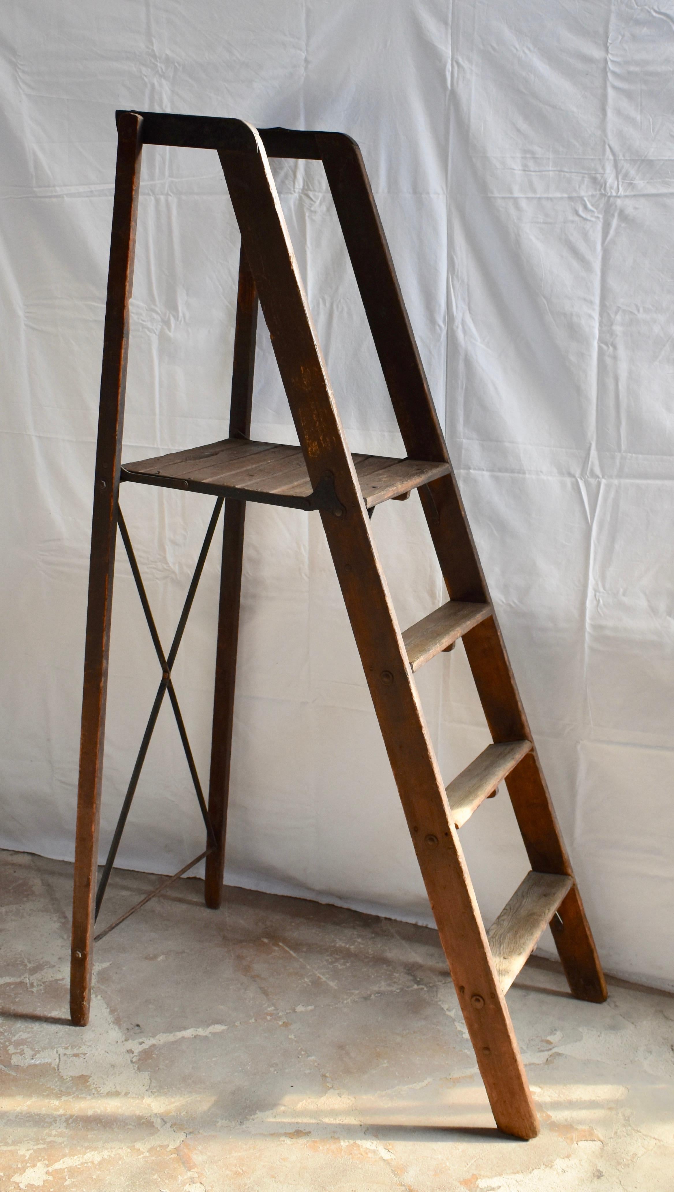 This pine and poplar folding library ladder has great form and color. All original wood and fasteners make this a wonderful decorative piece. Platform is 41