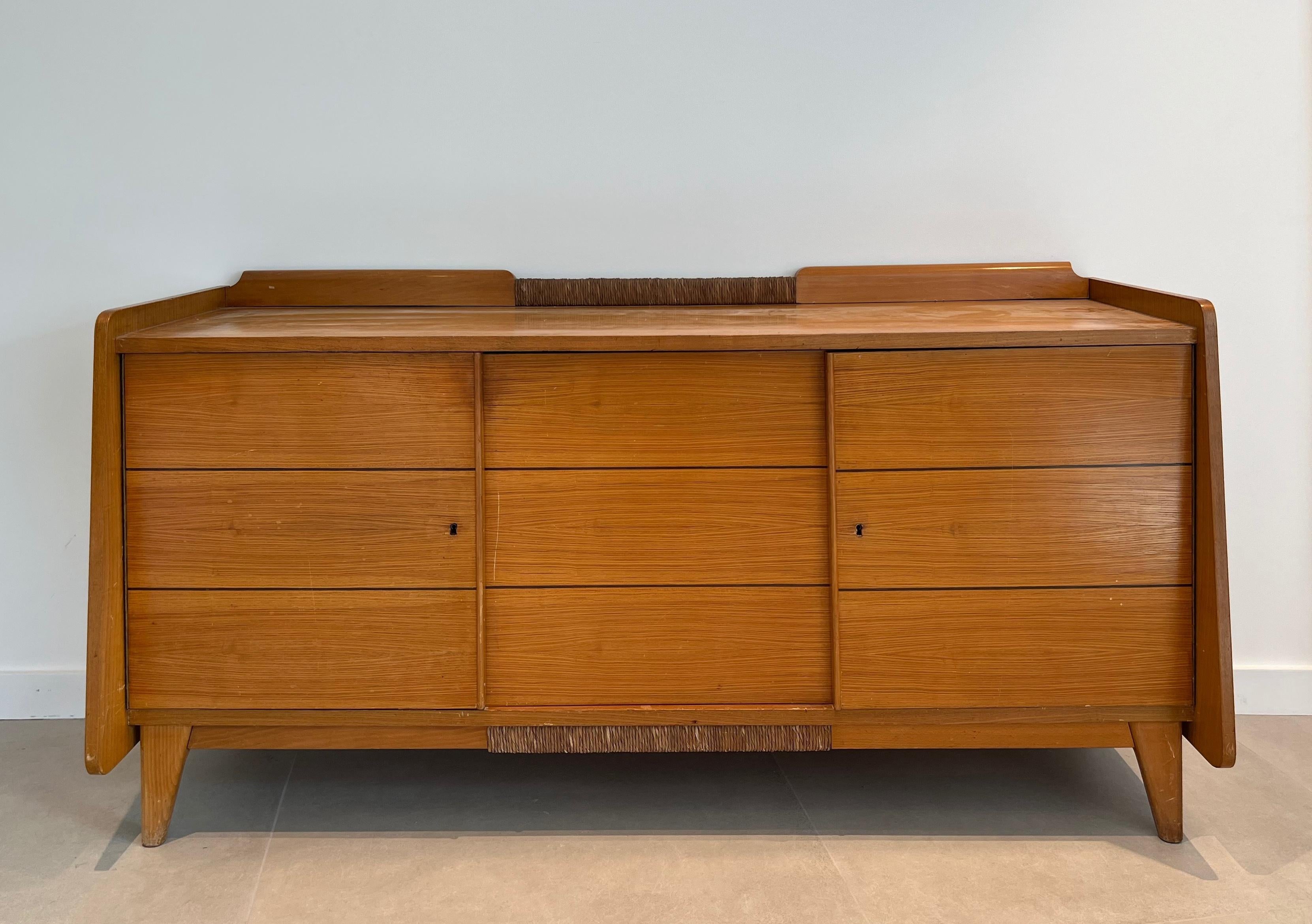 This very nice and decorative sideboard is all made of pine and rattan. This is a French work. Circa 1970
