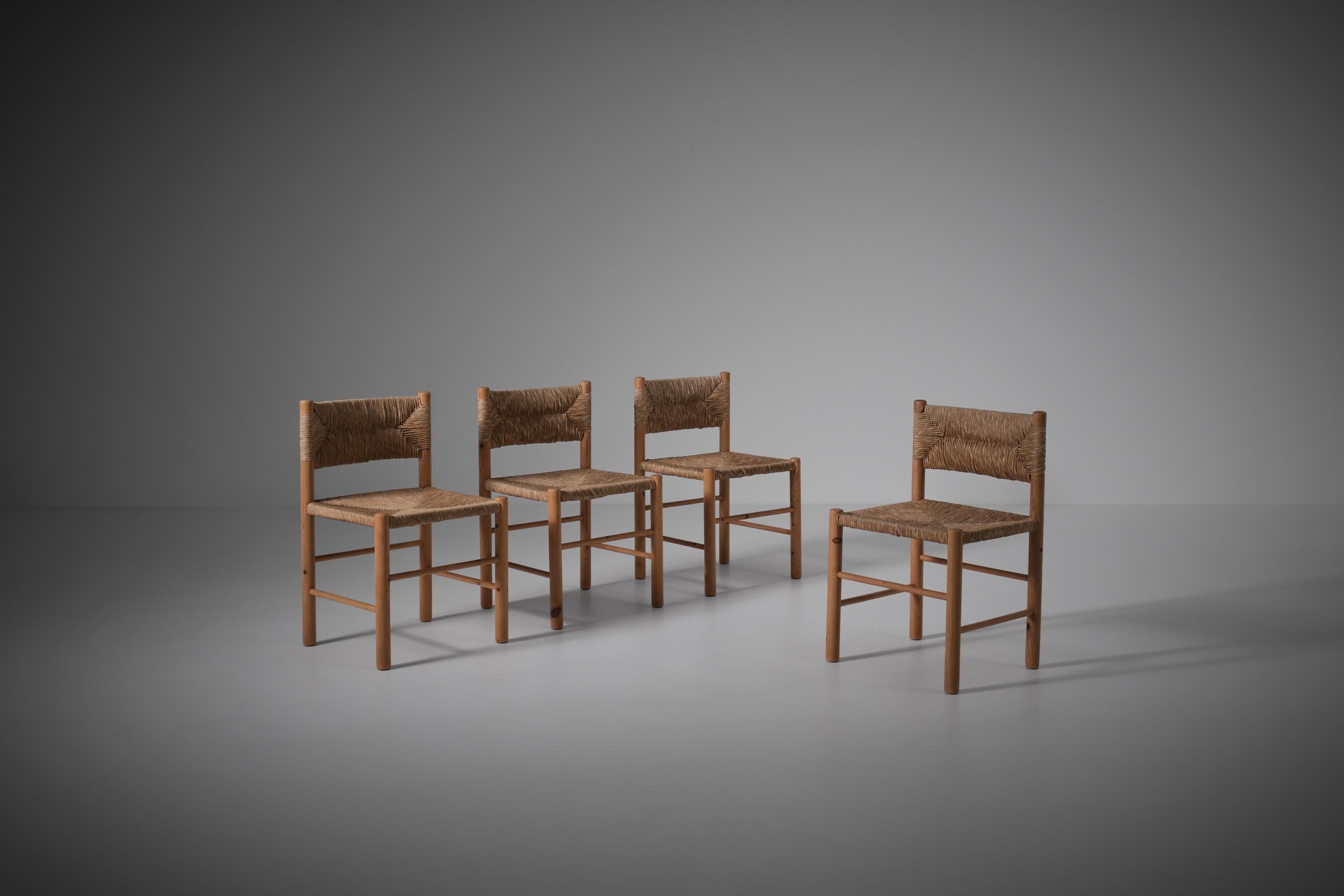 Set of four rustic dining chairs, 1960s. The chairs are made out of solid Pine and have a rush seat and backrest in a beautiful woven pattern. The chairs have many similarities with the 'Dordogne' chairs by Sentou. The main difference is that they