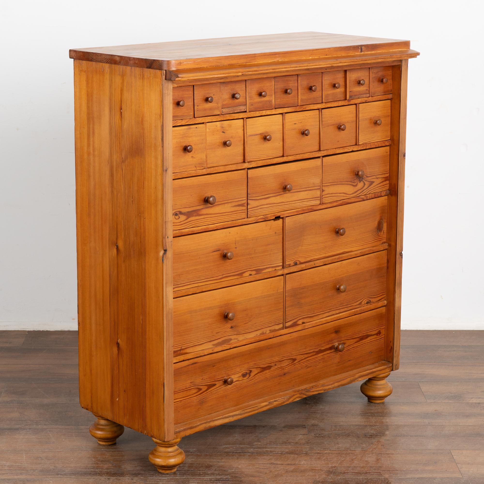 This pine apothecary is both a fun and functional chest of various sized drawers.
The many drawers with wooden pulls will serve well to organize and store items for a craft room or workshop.
Restored with a wax finish, each drawer functions. Note a
