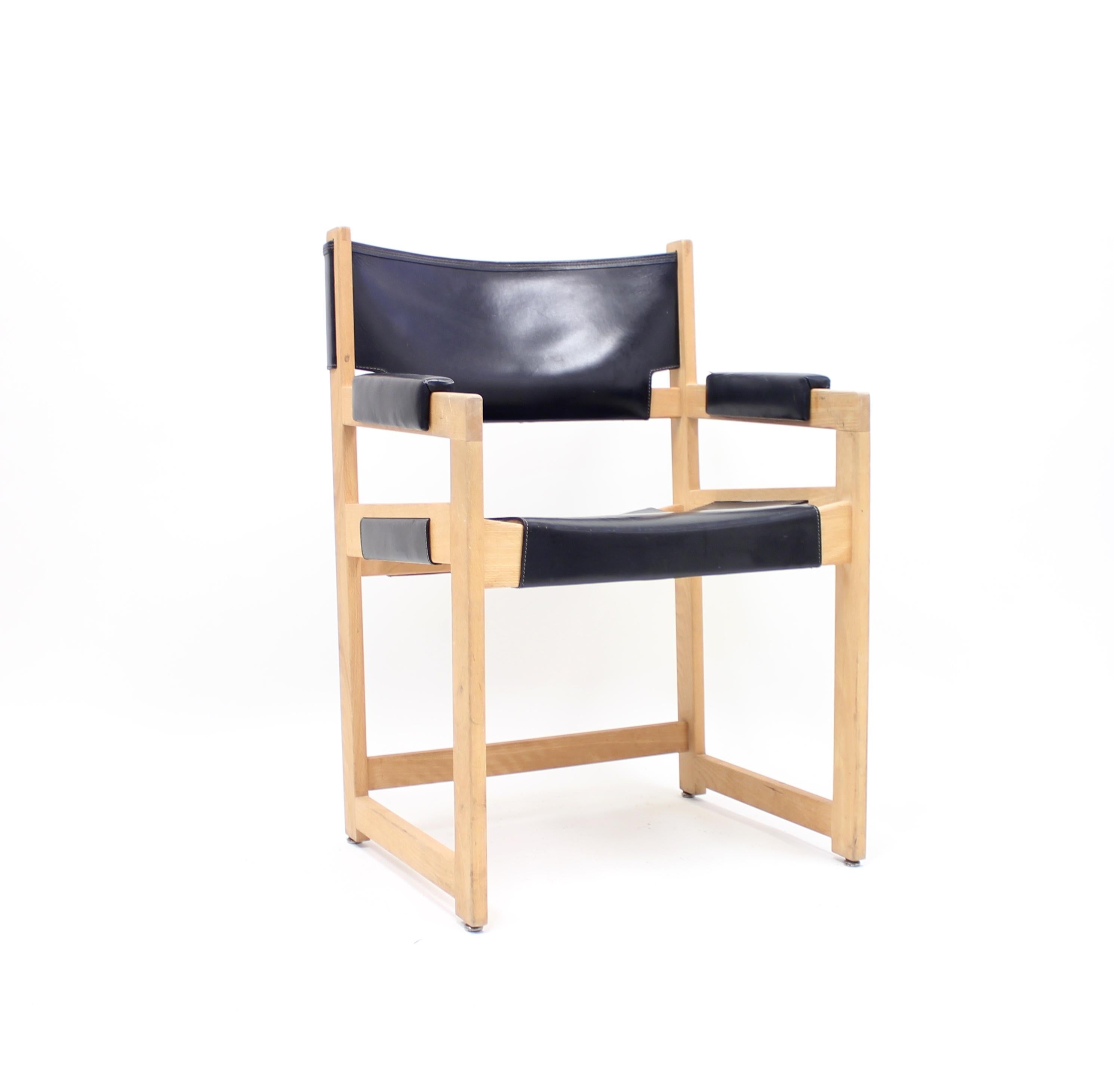 Armchair designed by Sven Kai Larsen for Swedish manufacturer Nordiska Kompaniet in the 1960s. It´s made of solid pine and black leather. This version is a bit more unusual because of the different type of armrests. Good vintage condition with light