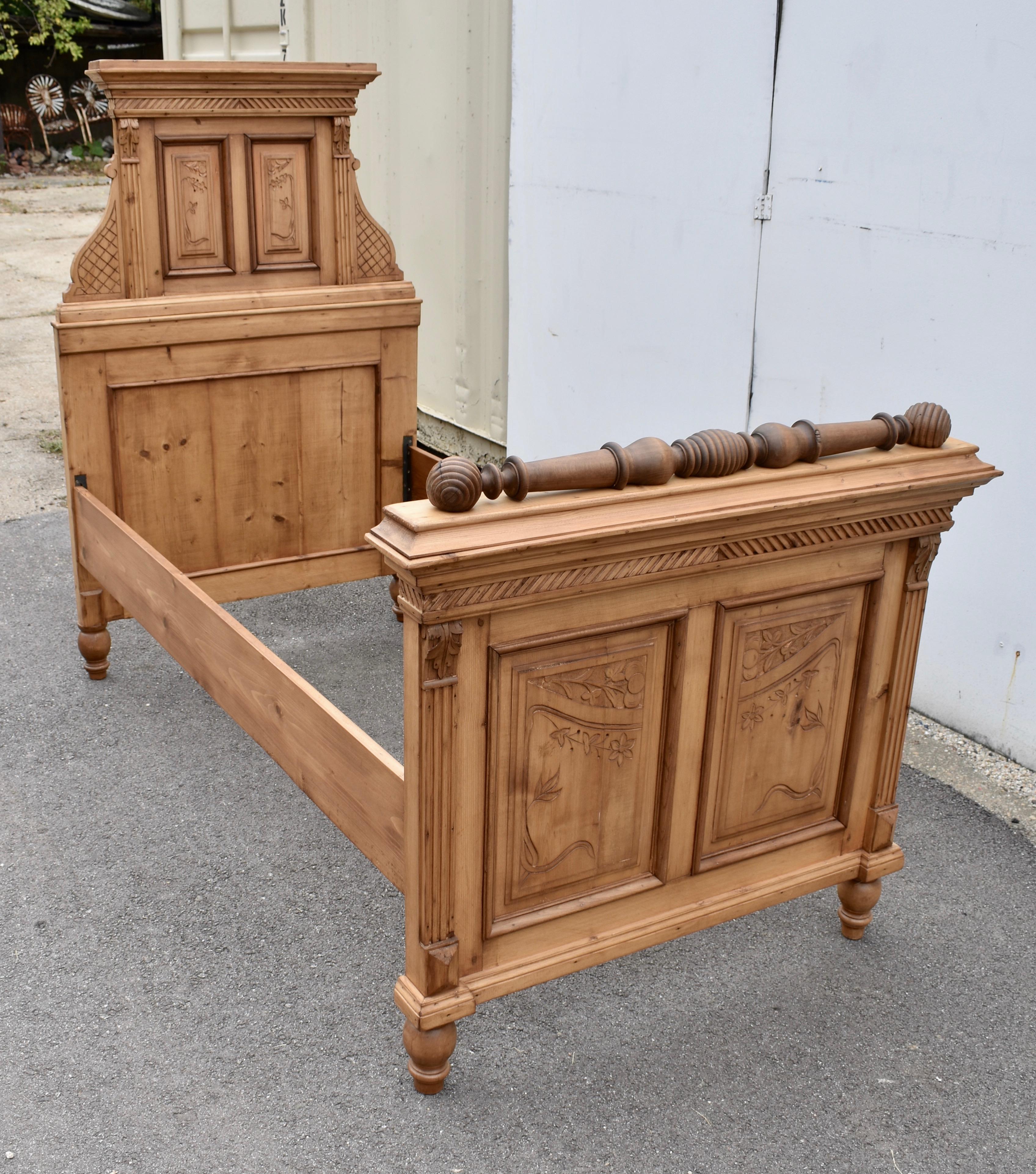 This fine Art Nouveau example is certainly one of the most decorative pine beds we have ever offered for sale.  The headboard is built in two parts.  The lower part consists of a flat panel, framed with thick rails and stiles and hardwood mullions